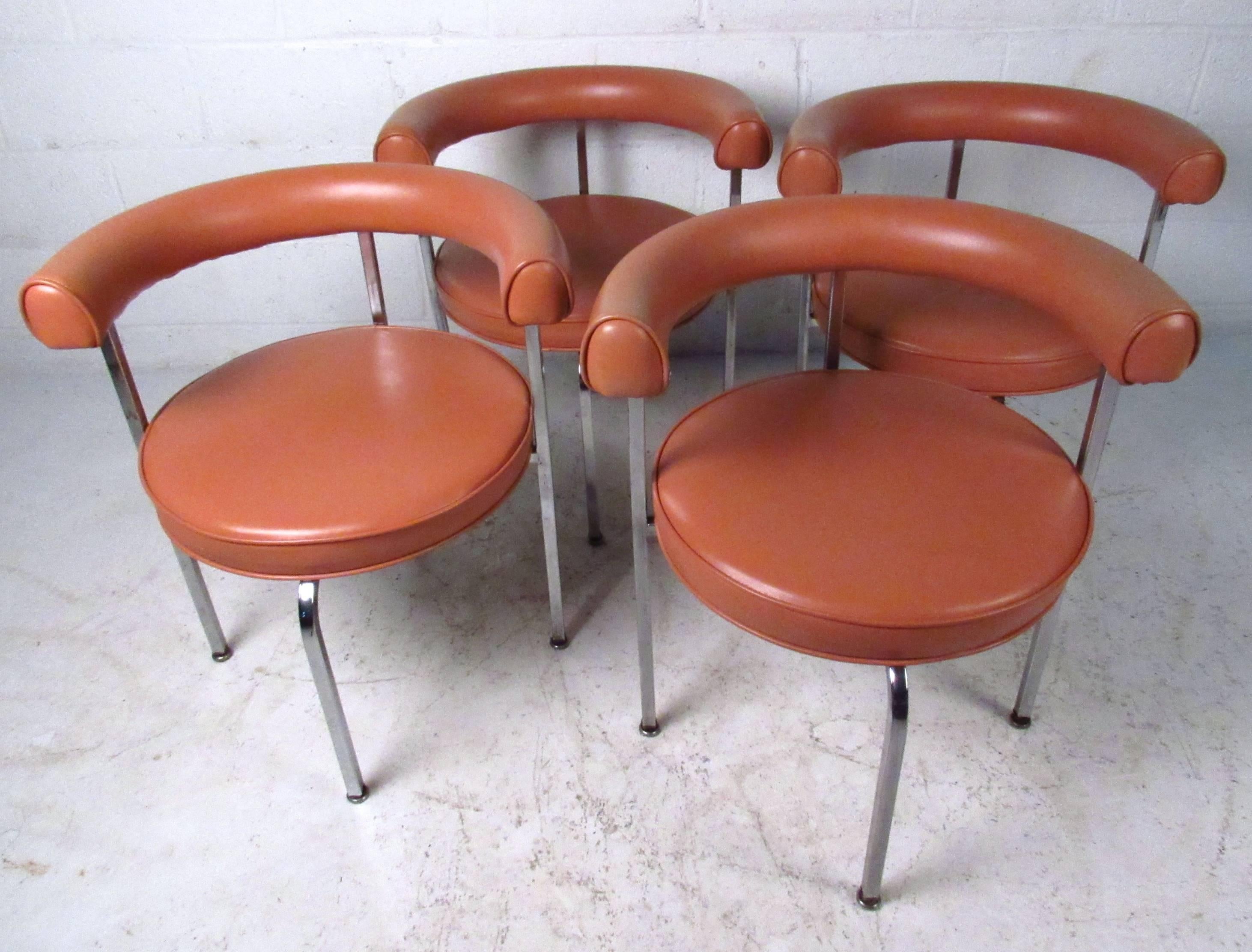 This set of four vintage chairs feature a unique style similar to the LC7 by Le Corbusier. Comfortable rounded seat backs and sturdy chrome frame make this a stylish addition to any interior, and great for occasional or dining use. Please confirm
