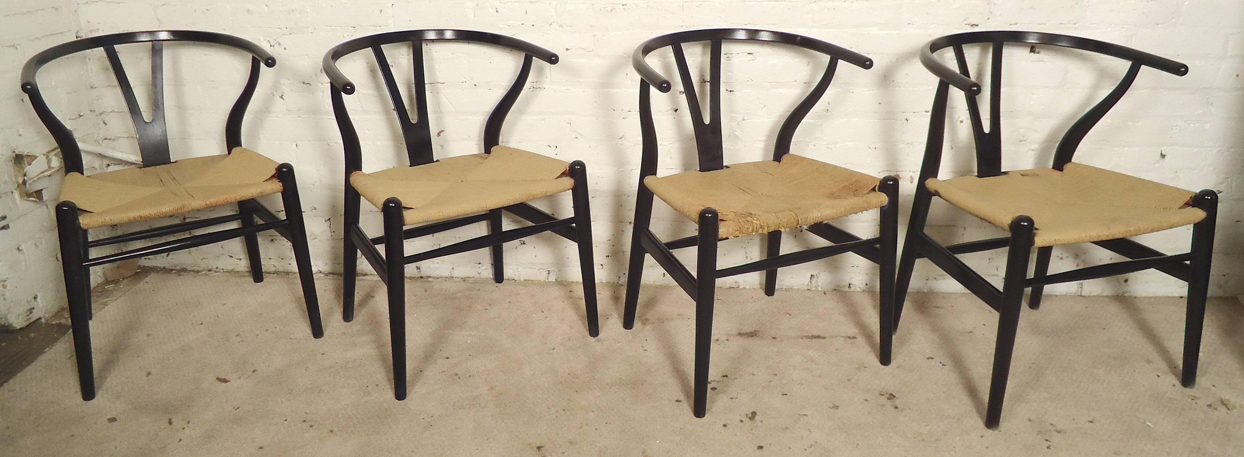 Mid-Century Modern set by Hans Wegner refinished in black. Paper cord seats, sculpted frames, 