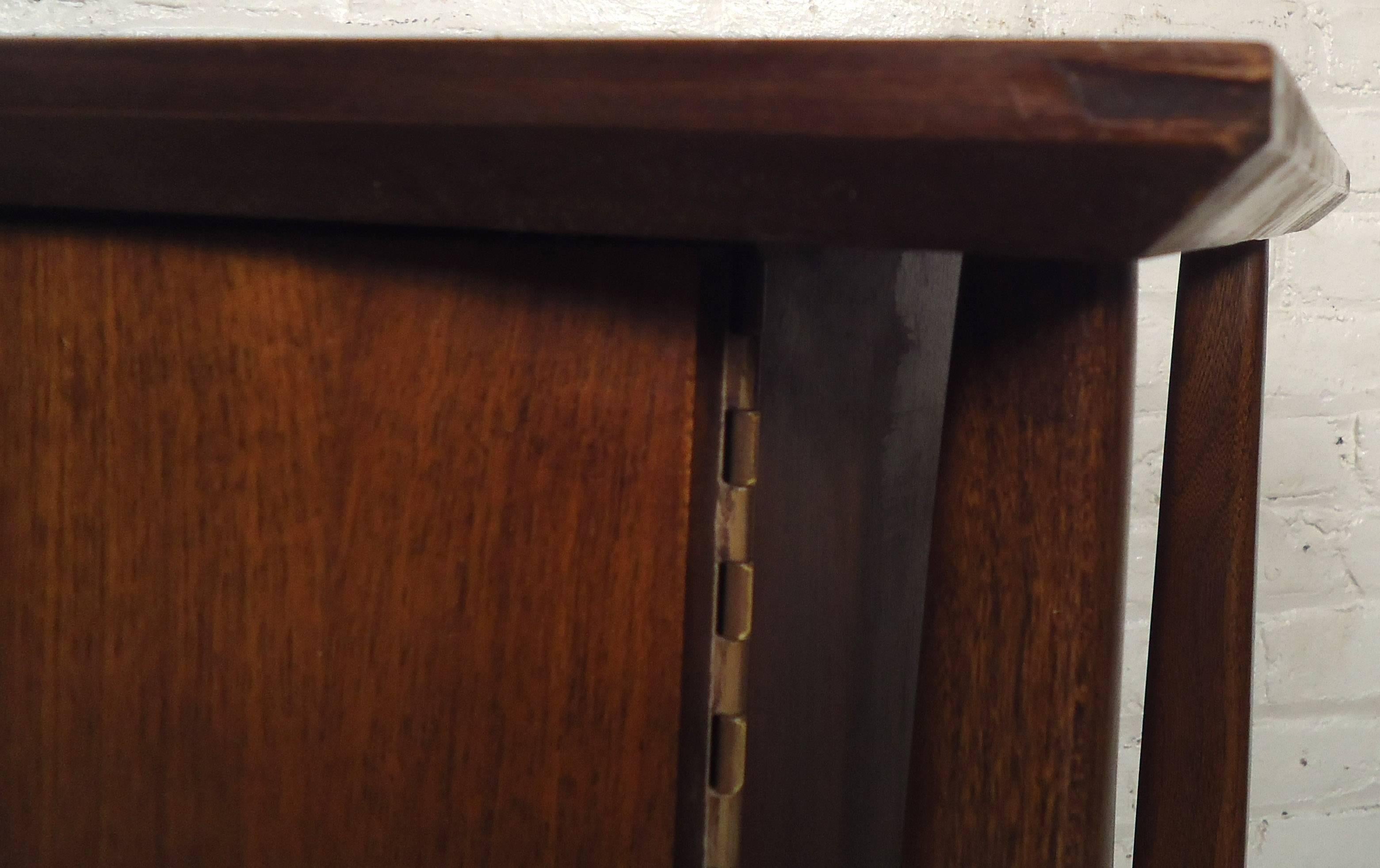 Two vintage-modern nightstands each featuring beveled top, sculpted legs and two door cabinets with brass handles.

Please confirm item location NY or NJ with dealer.