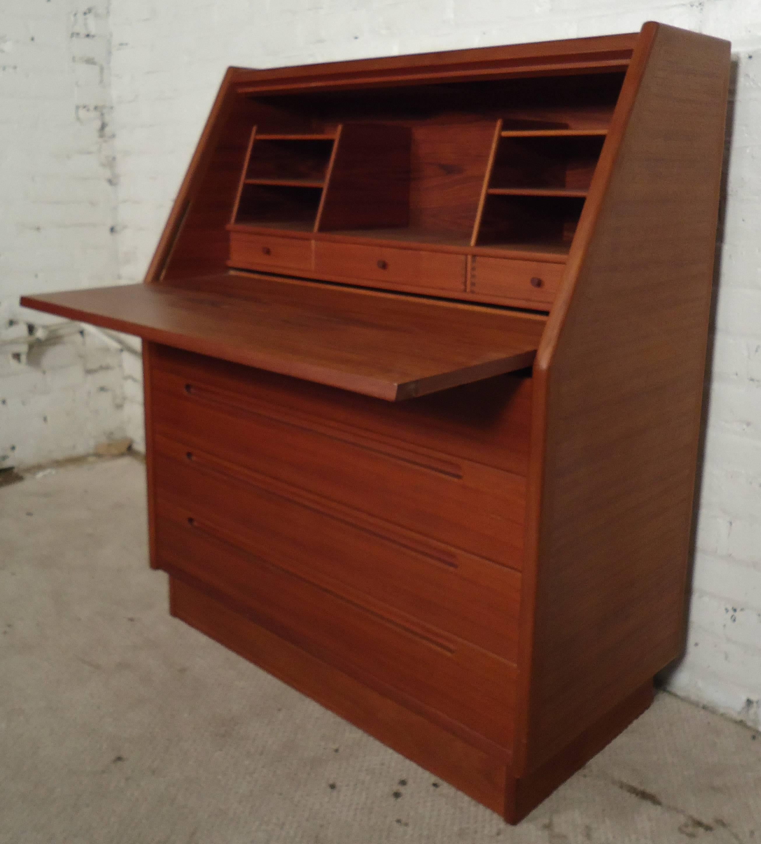 Vintage-modern Danish desk by Torring Mobelfabrik, features drop front writing station revealing interior storage compartments and drawers, Bottom front has four large drawers with sculpted handles.

Please confirm item location NY or NJ with