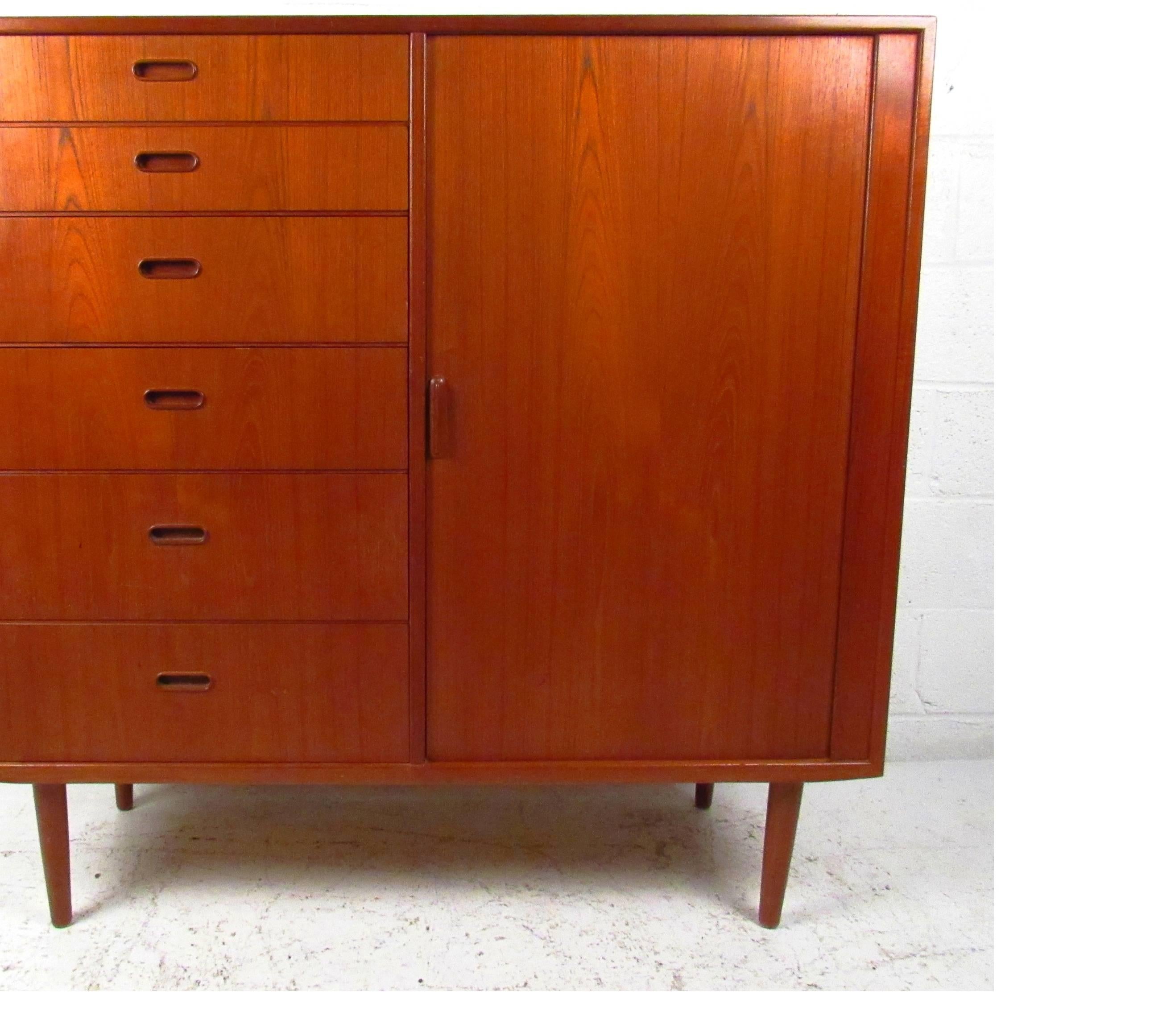 Well designed 12-drawer teak dresser with tambour door by Falster Mobelfabrik offers spacious storage drawers in any setting. Please confirm item location (NY or NJ) with dealer.