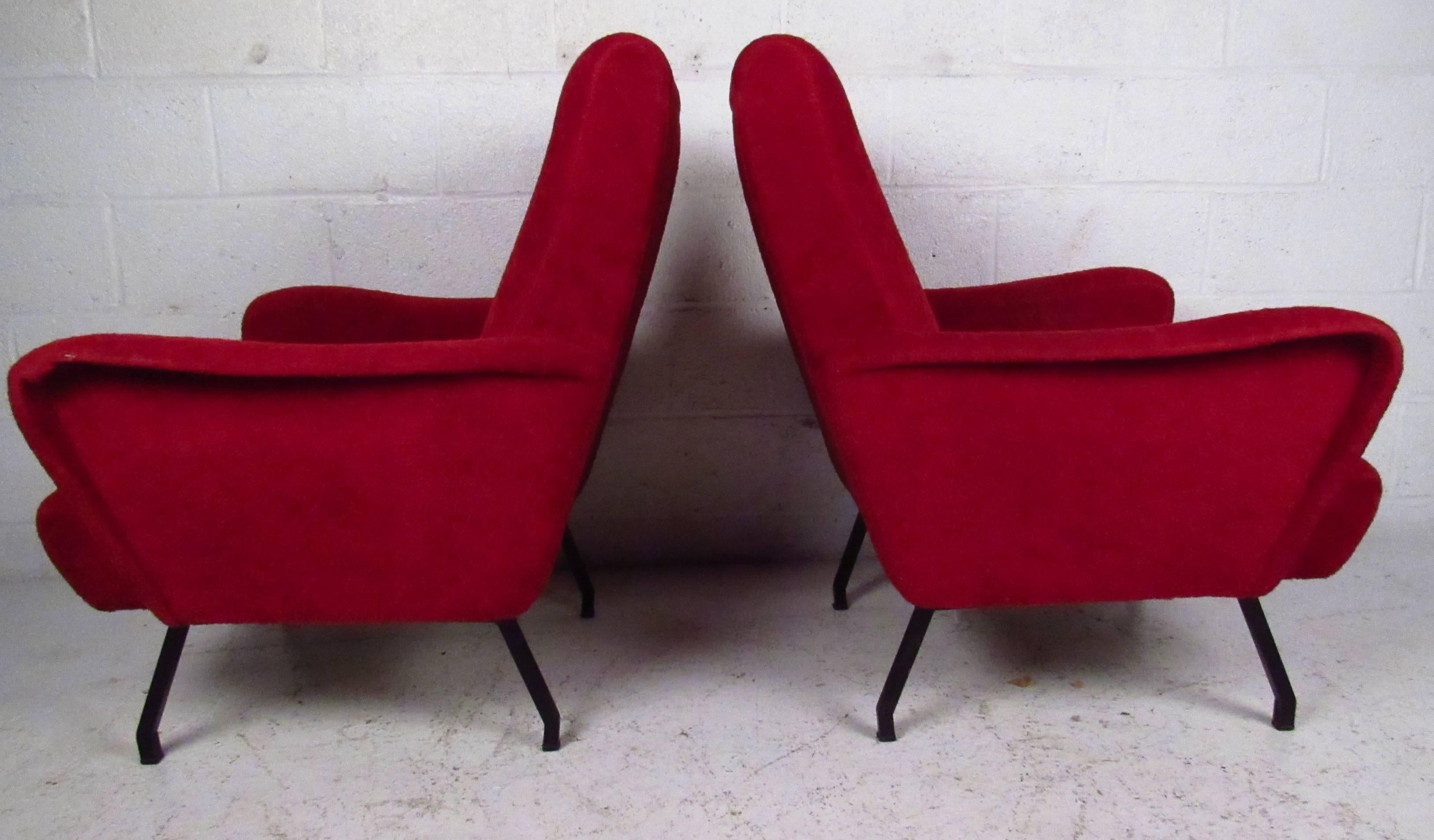 This stylish pair of upholstered lounge chairs with angled metal legs and sculpted arms add to the Italian modern appeal of the set. Perfect pair of vintage high back lounge chairs make a comfortable addition to any interior. Please confirm item