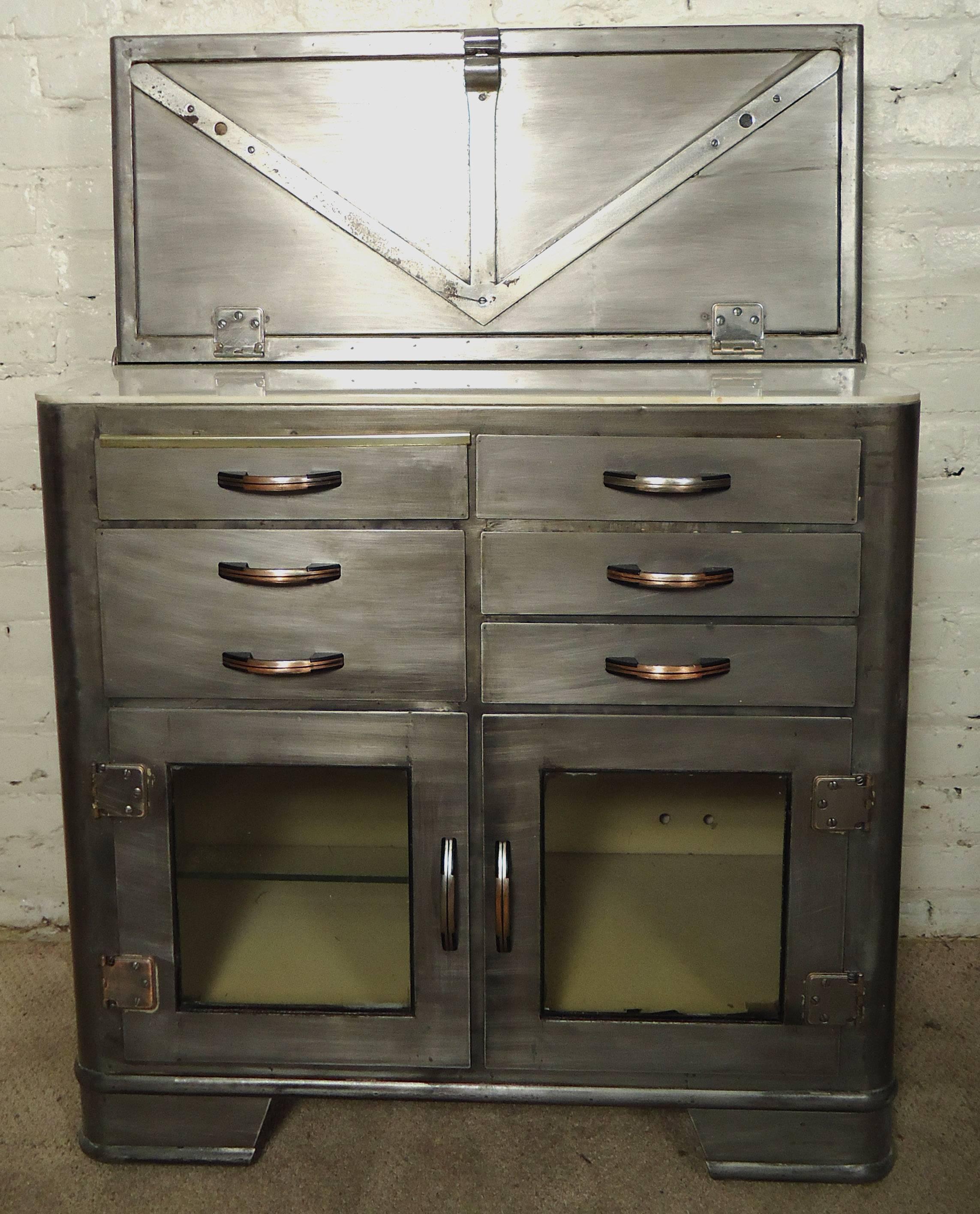 Industrial doctors cabinet, makes for a great modern kitchen or bathroom cabinet. Features drop down front with storage, bottom drawers and glass doors.

(Please confirm item location - NY or NJ - with dealer)
