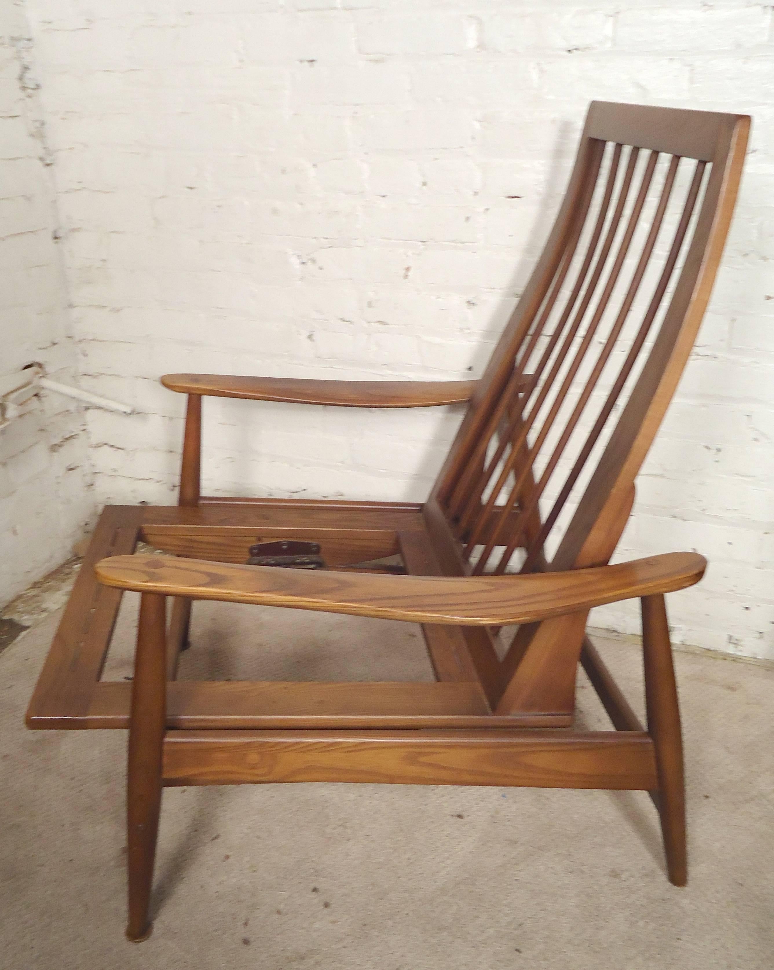 Pair of vintage armchairs in walnut with rocking motion. High sculpted back, long arms, spring action seat for comfortable rocking movement.

(Please confirm item location NY or NJ with dealer).
 