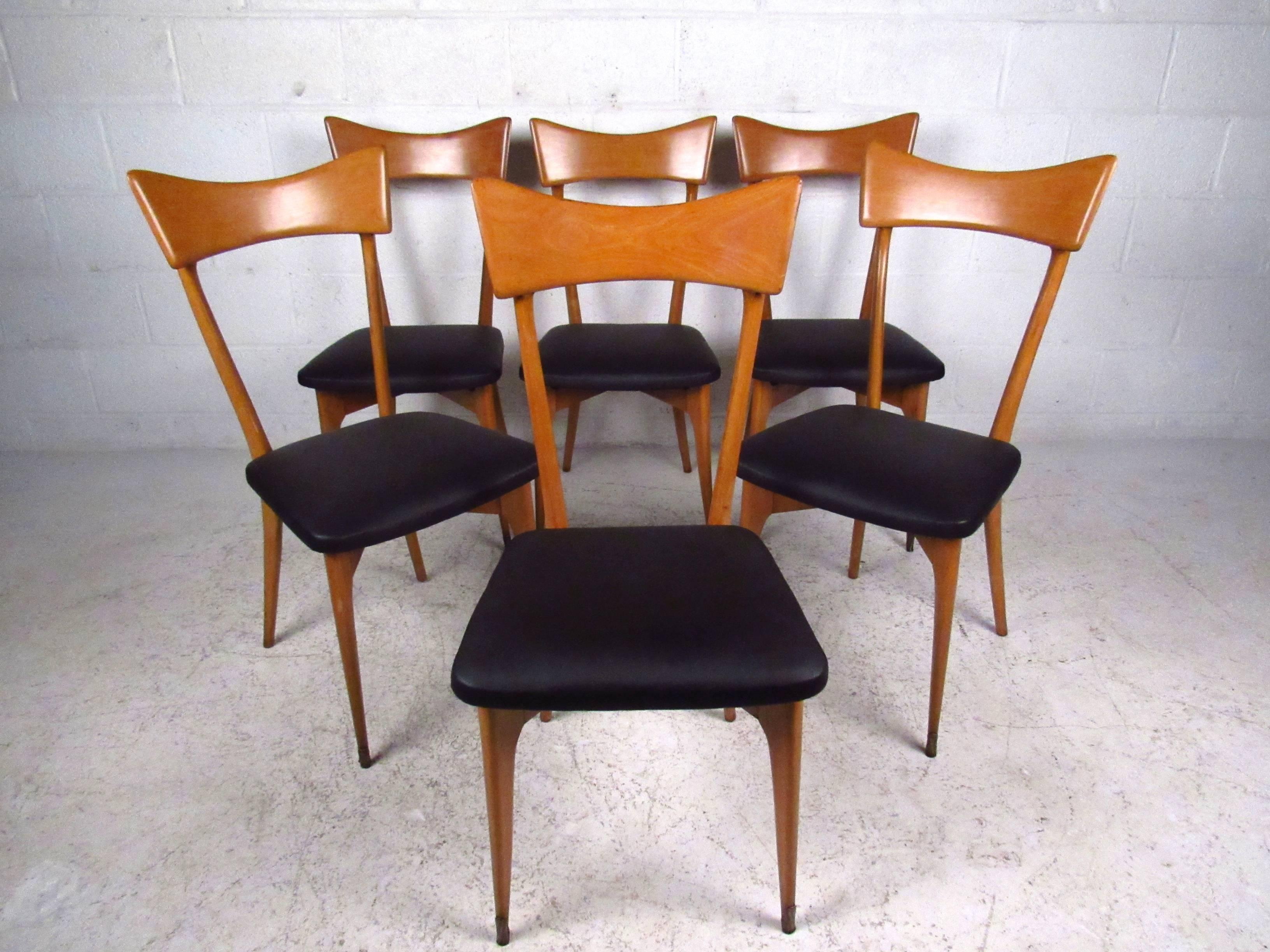This beautiful set of six vintage Italian dining chairs feature the beautiful design of Ico Parisi. Gorgeous sculpted seat backs, tapered legs, brass foot guards (front legs) and newly reupholstered seats make these a unique addition to any dining