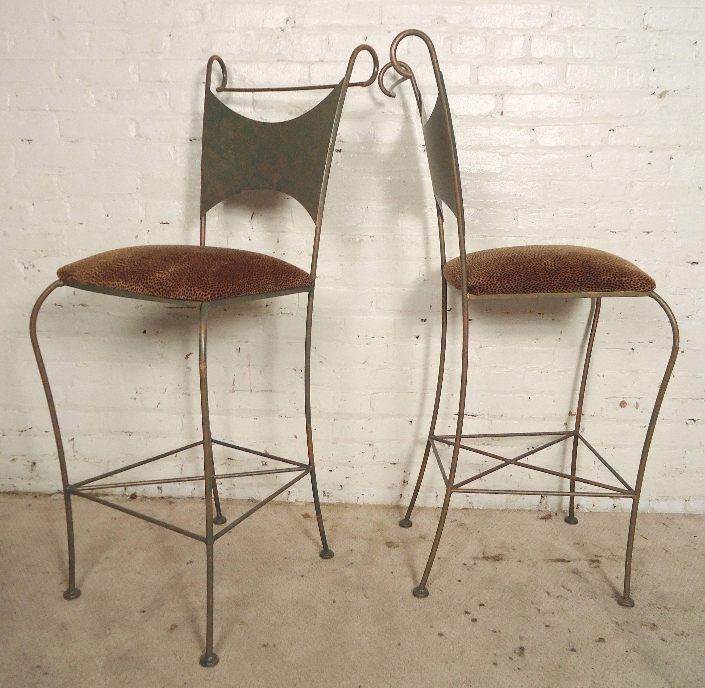 Set of wild iron stools with leopard print seats. Bent iron frames with scrolled backs and square footrests. They add great style and texture to your bar.

(Please confirm item location - NY or NJ - with dealer)
