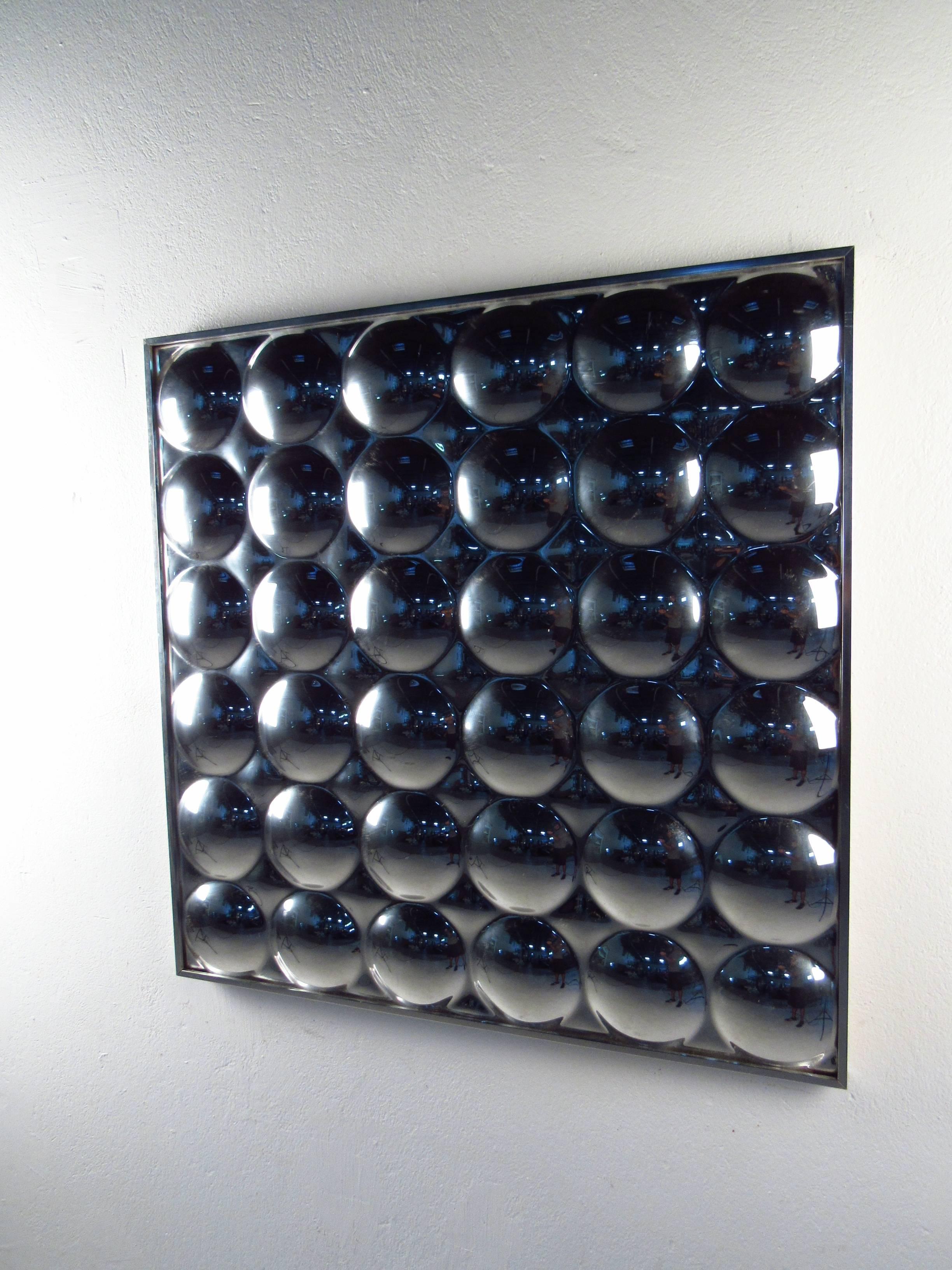 This stylish vintage wall art features 36 mirrored bubbles complete with chrome frame. The plexi-view mirror reflects and refracts everything in the room, making a unique statement in any interior. (Please confirm item location NY or NY.)