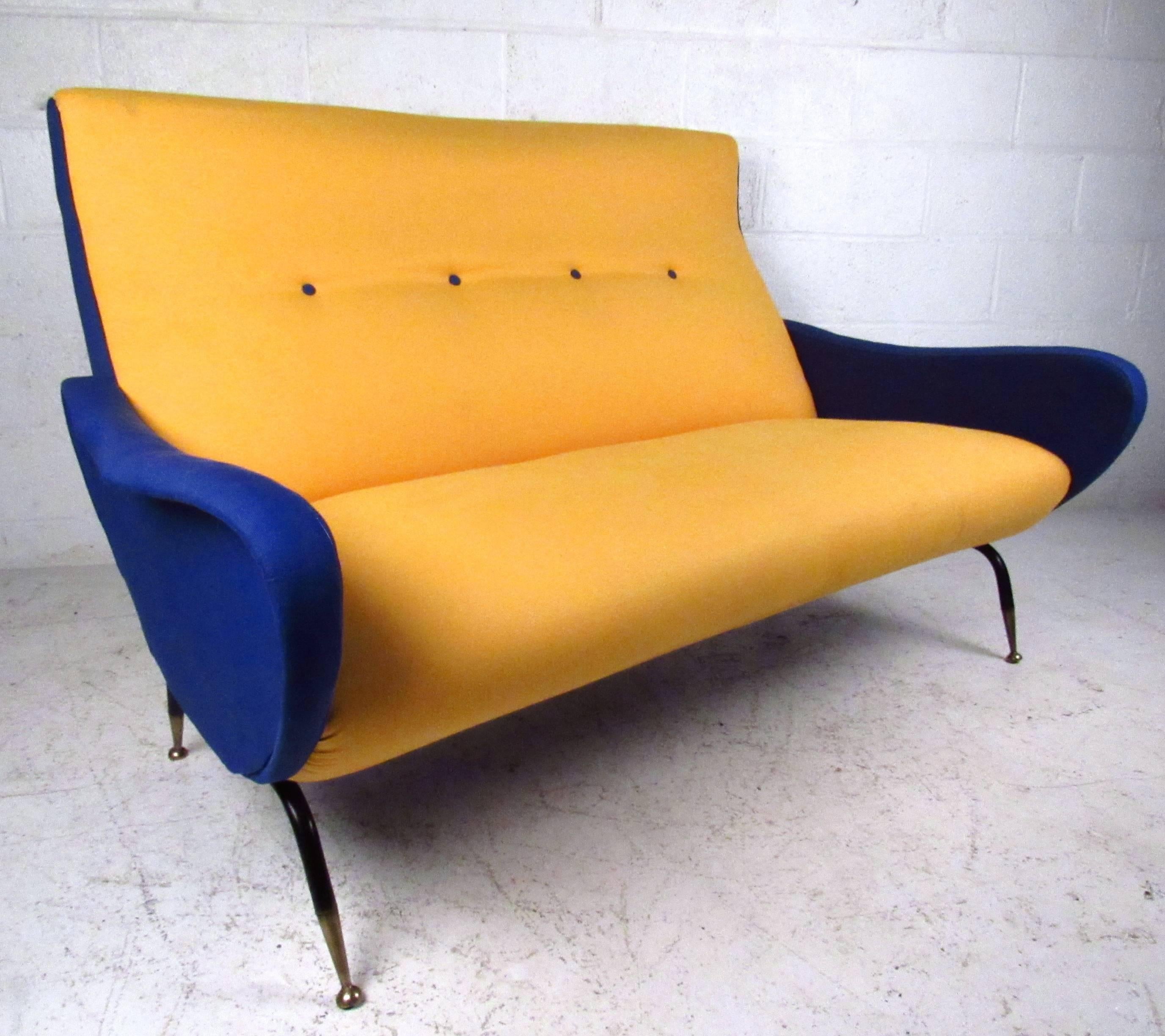 This uniquely upholstered sofa has a truly spectacular design, including curved back, sculpted arms, and wonderful tapered legs complete with brass feet. Stylish approach calls out to vintage Italian designers like Marco Zanuso and Gio Ponti.