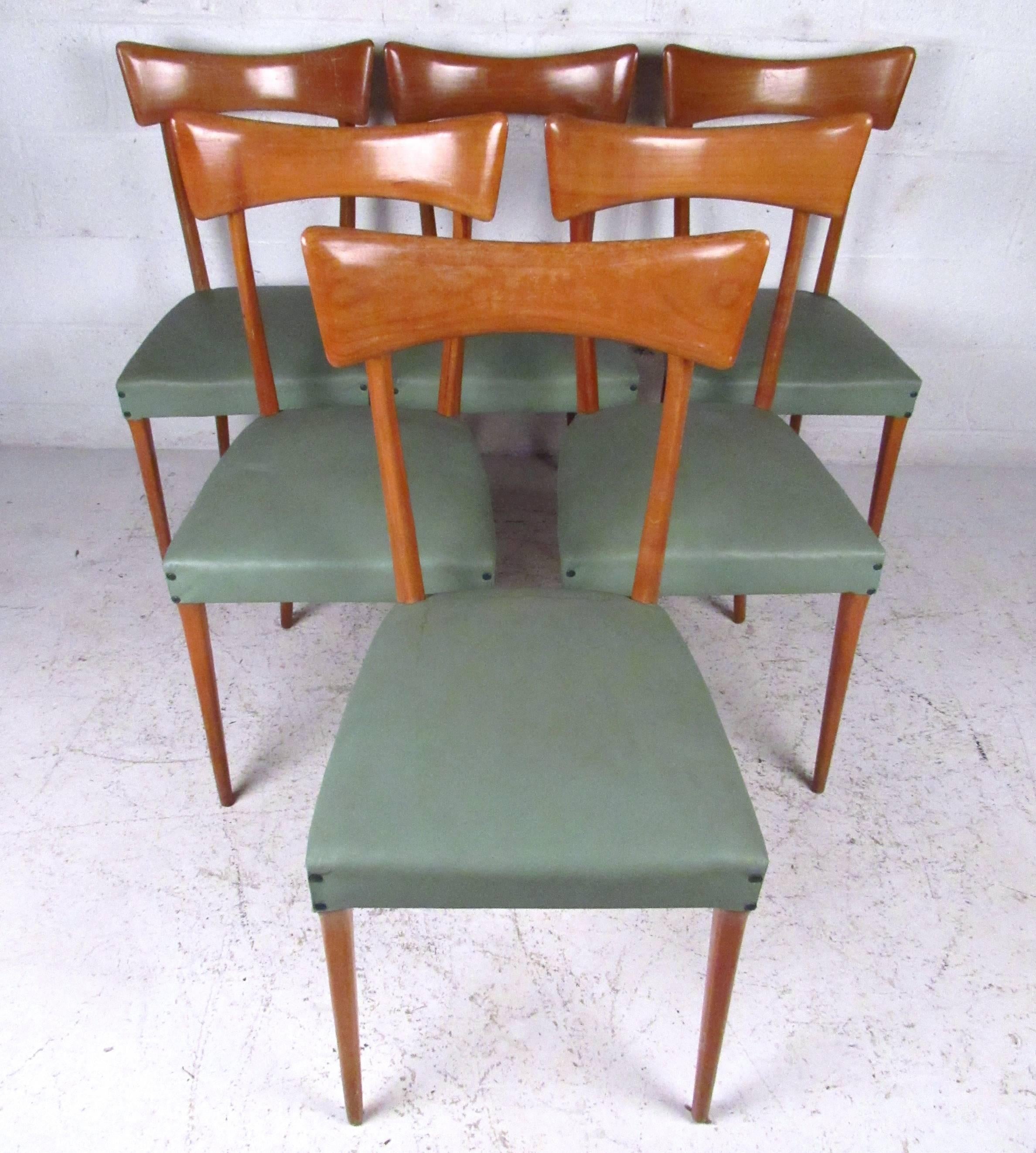 This set of six vintage dining chairs features shapely seat backs and tapered legs, still in sturdy condition. Elegant and stylish set for any modern interior, please confirm item location (NY or NJ).