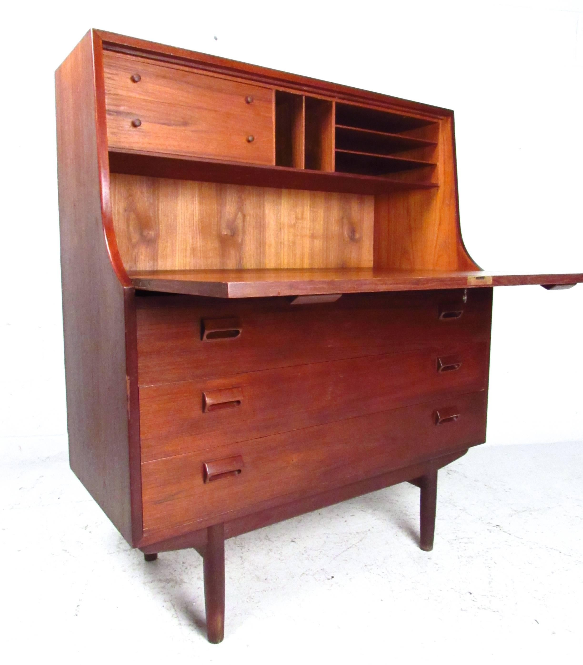 This unique Børge Mogensen style secretary desk offers a combination of workspace and storage, making an ideal addition to settings short on space. Plenty of room for organization and paperwork, this vintage teak secretary is a great addition to