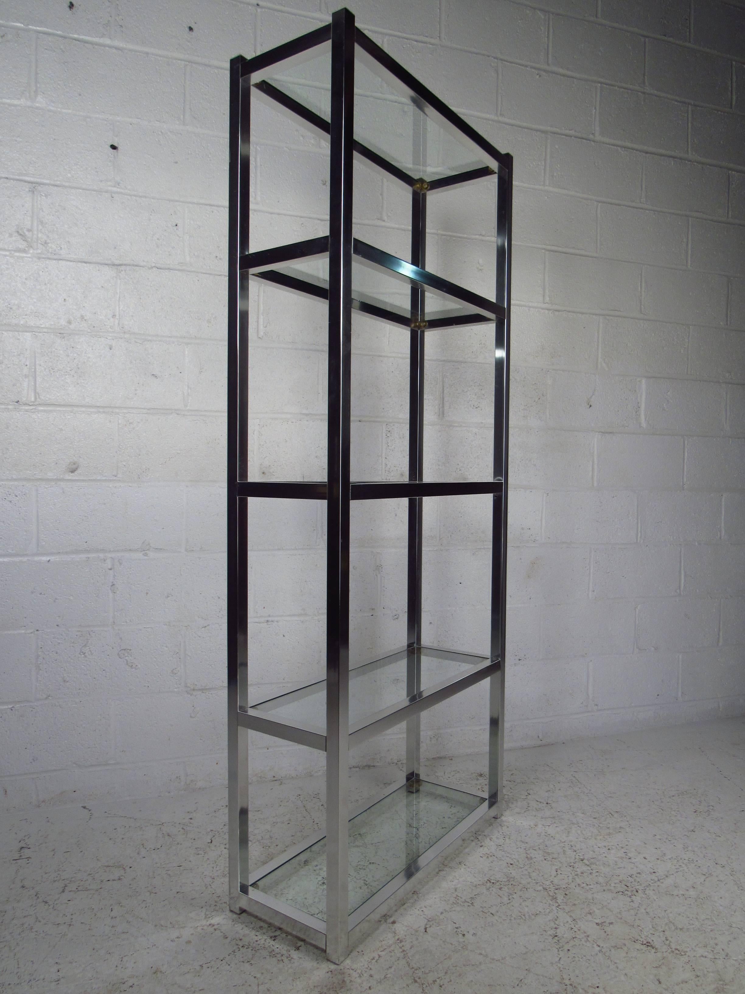 This gorgeous étagère is constructed with brushed aluminum and features five glass shelves, making it ideal for storefront or a living room display case. The stylish and sturdy design fits well in any home or business setting. (Please confirm item