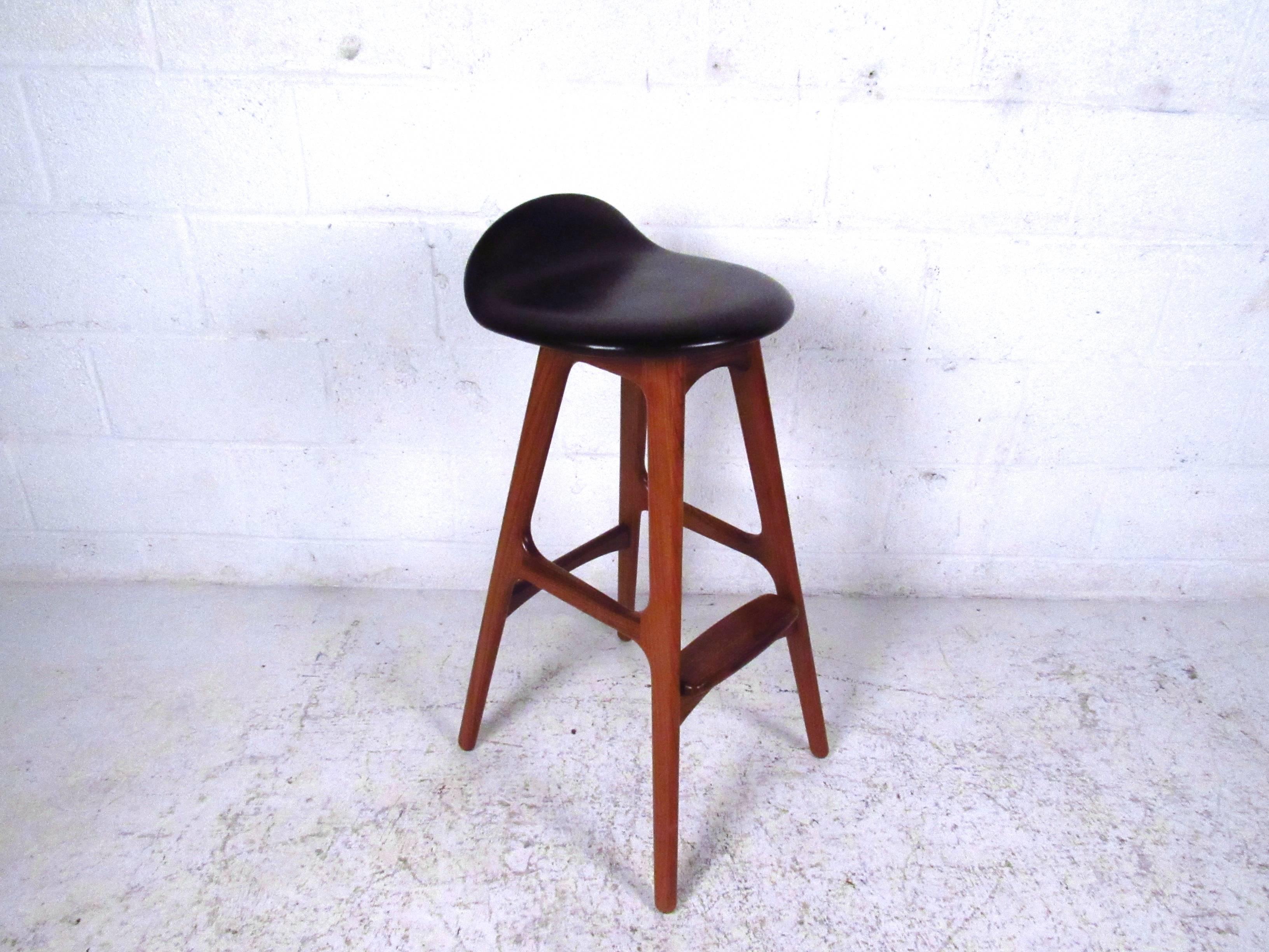 This unique pair of Erik Buck designed teak frame stools offer simple, stylish, and comfortable seating for a variety of interiors. Tapered legs, raised seat back, and quality construction make these a wonderful addition to home or business. Please