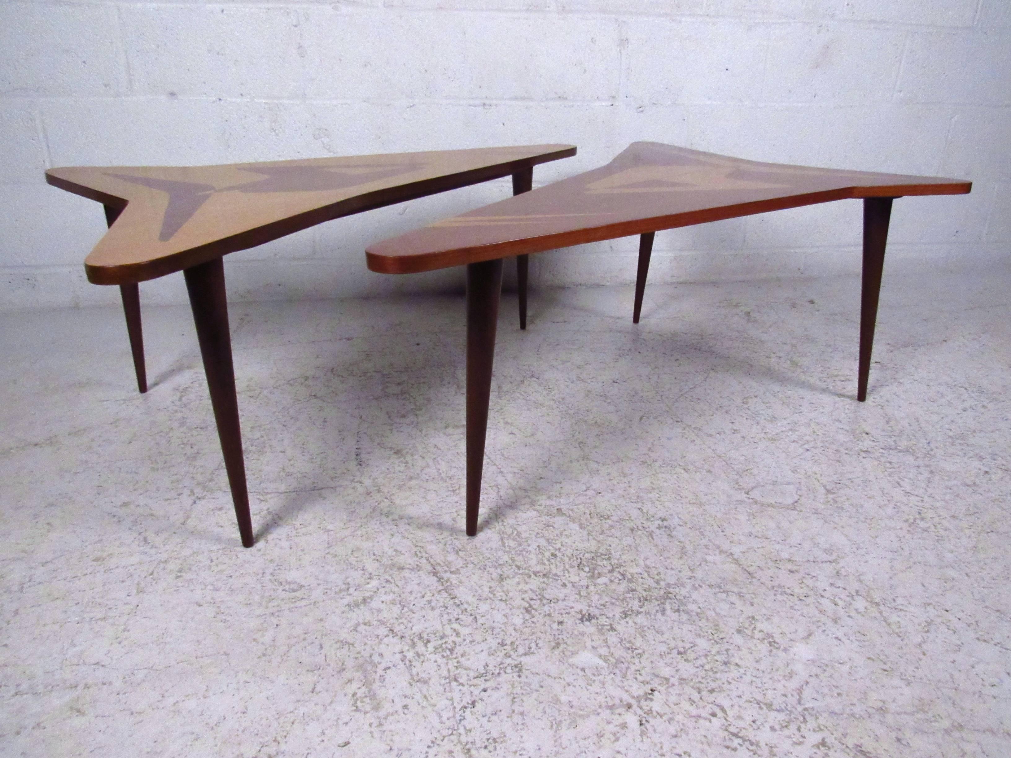This unique sculptural coffee table features unique shape, quality construction, and elegant marquetry inlay. Tapered legs and Italian style make this a wonderful mid-century addition to any interior. Price is for one table, please confirm which of