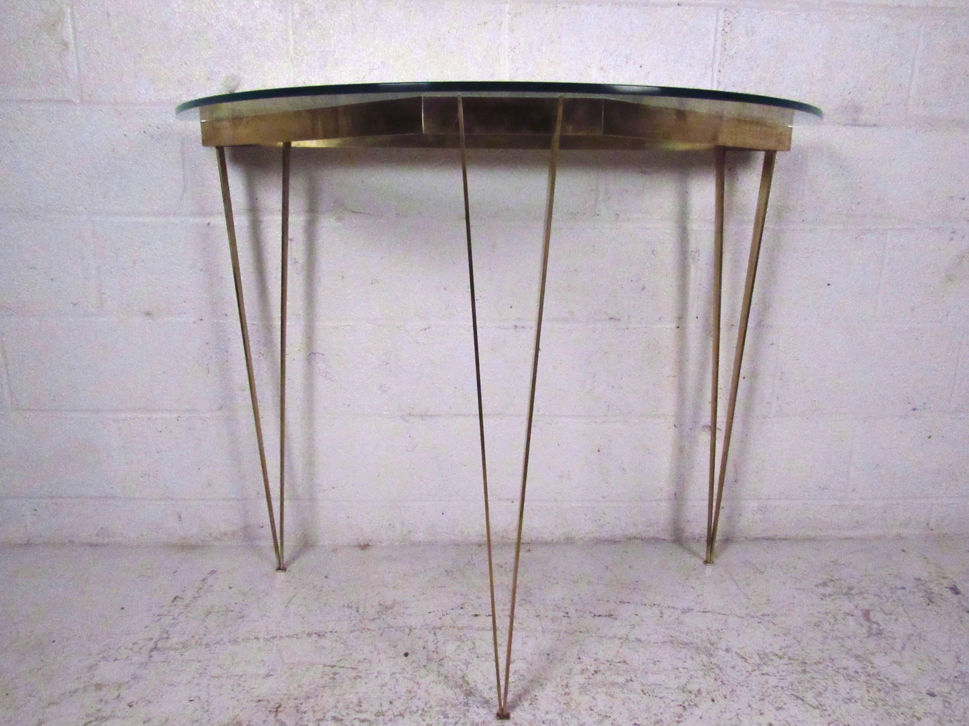 This unique vintage table features bronze finish hairpin legs with demilune glass top, and makes an excellent addition to entryway or display area. Flat stock bronze makes this a stylish and elegant piece for any interior. Please confirm item
