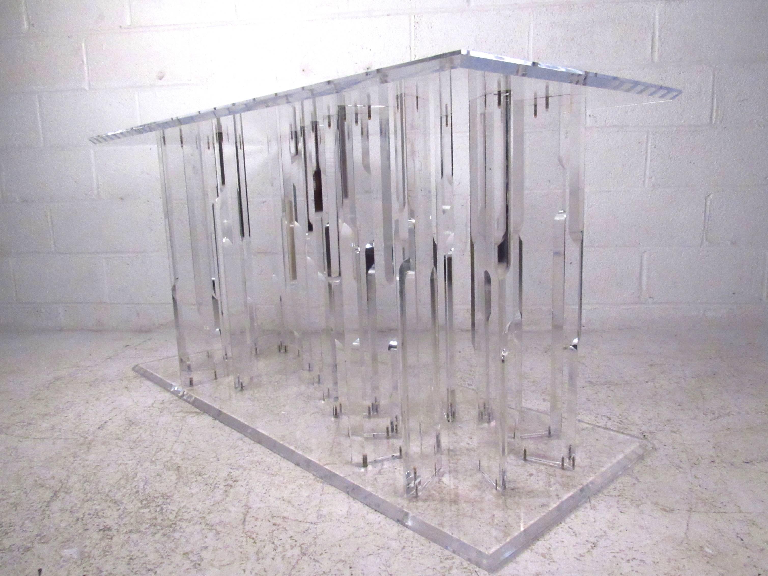 This elegant Lucite table features sculpted Lucite construction with beveled edges, making a wonderful modern addition to any setting. Suited for use as a sofa table, hall table, or centre table it's unique vintage design is perfect for making a