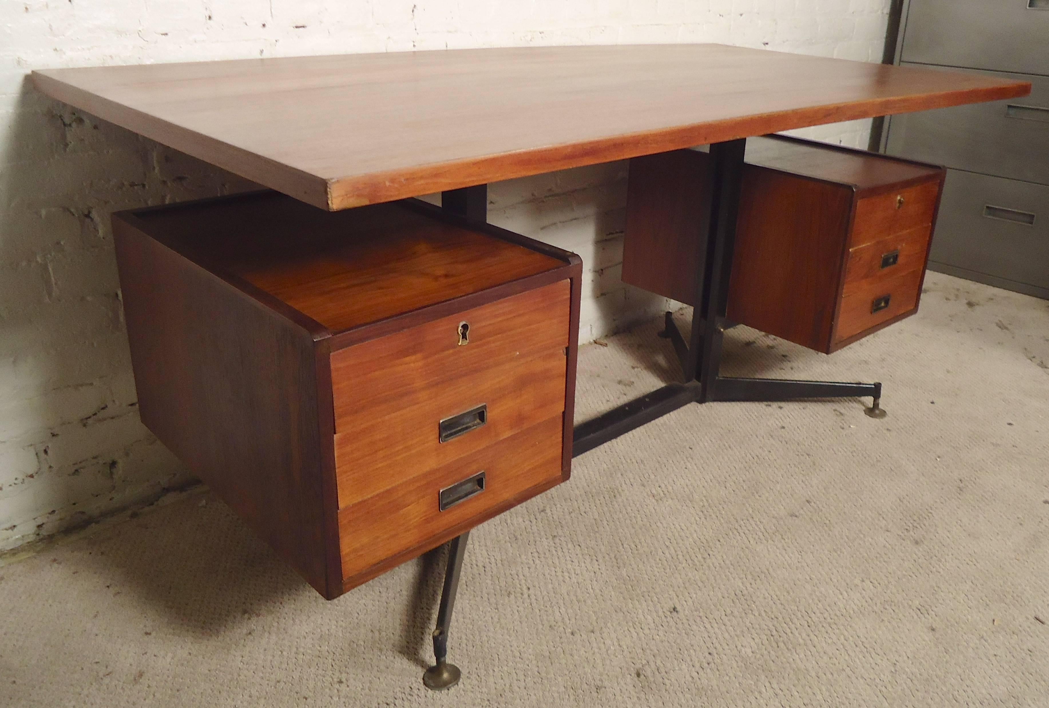 Gorgeous teak desk with Antonio Fornaroli design. Long teak top, floating attached drawers, iron frame.

(Please confirm item location - NY or NJ - with dealer).
 