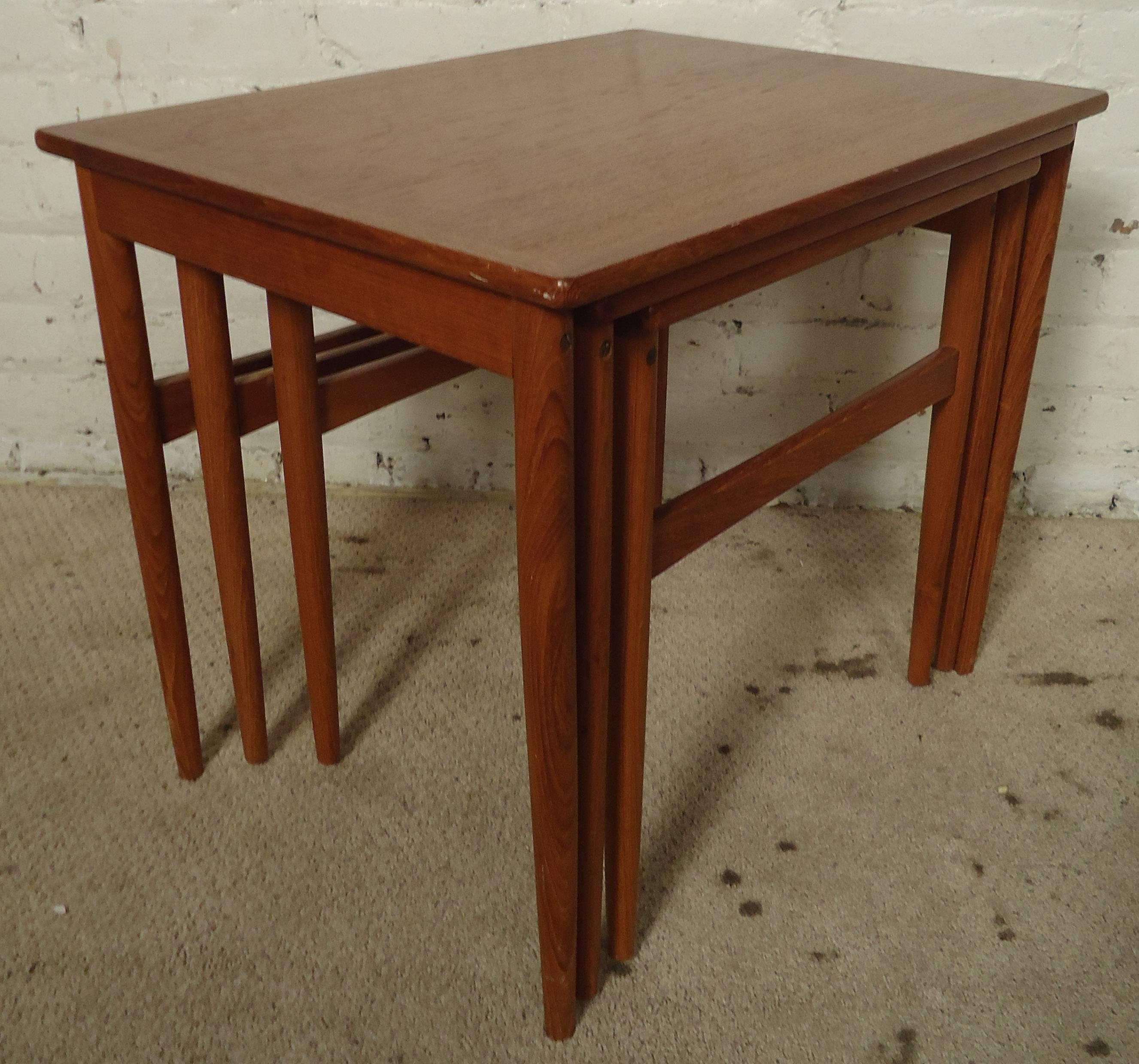 Three vintage-modern Danish nesting tables features sculpted legs and beautiful wood grain throughout. 

Dimensions - 21.5w 16.5d 18h
                      19w 15d 17h
                      16w 13d 16.5h

Please confirm item location NY or NJ