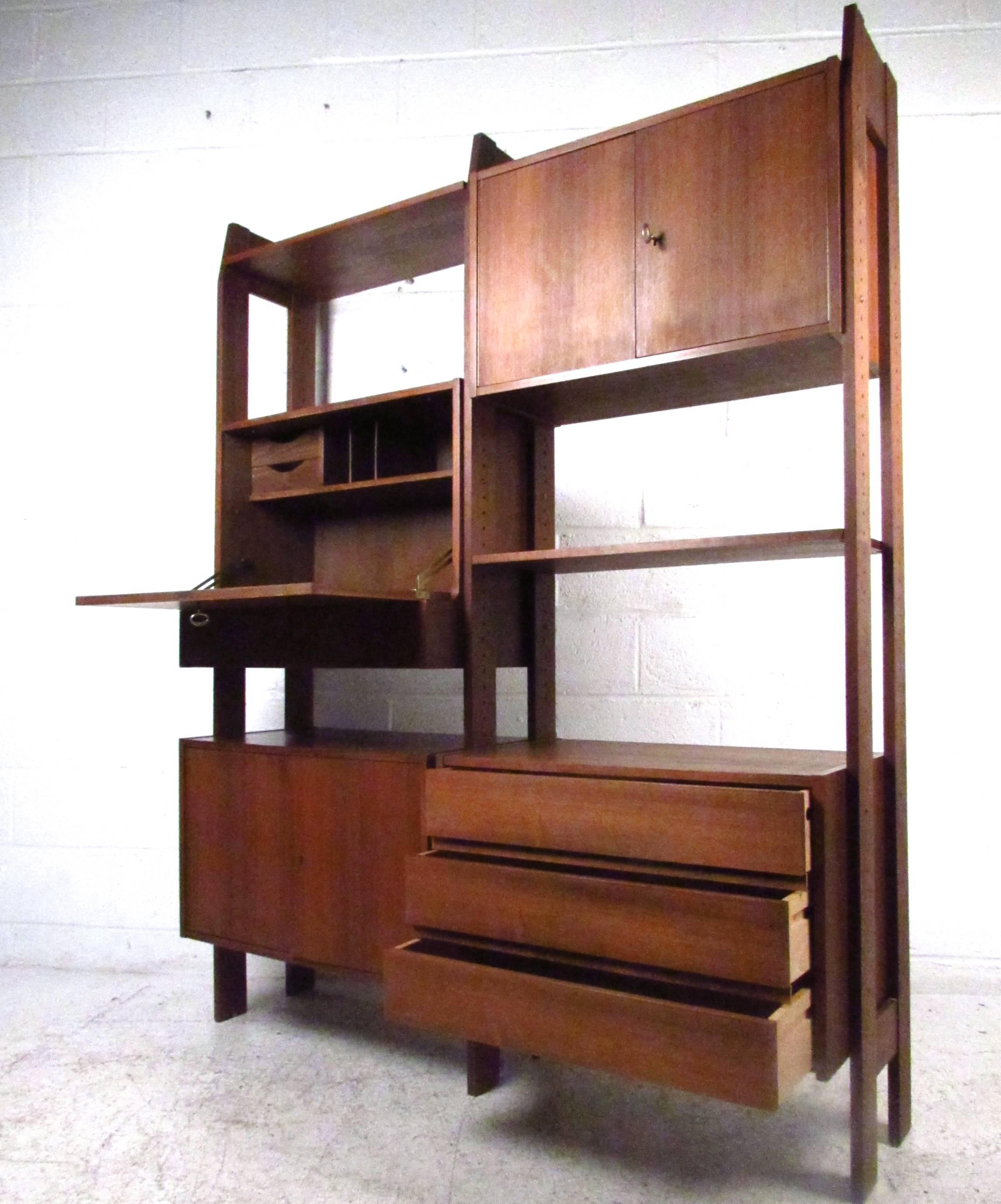 This walnut wall unit can be arranged in any formation you desire, and provide a unique combination of storage, display, and workspace. Please confirm item location (NY or NJ).