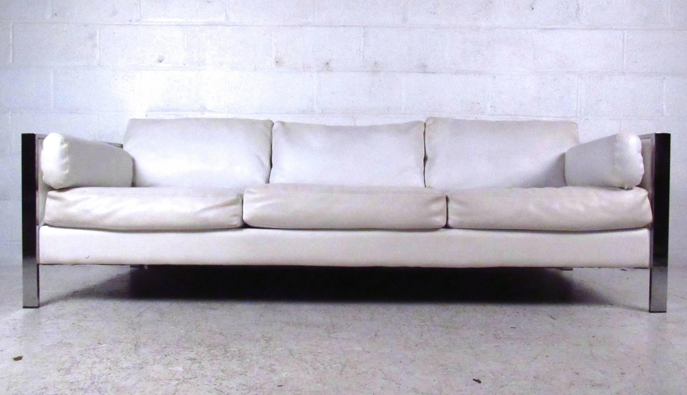 This vintage vinyl sofa features comfortable cushioning and sleek midcentury design. Sturdy chrome frame with strong lines adds to the appeal. Comfortable and stylish seating addition to any interior. Please confirm item location (NY or NJ).