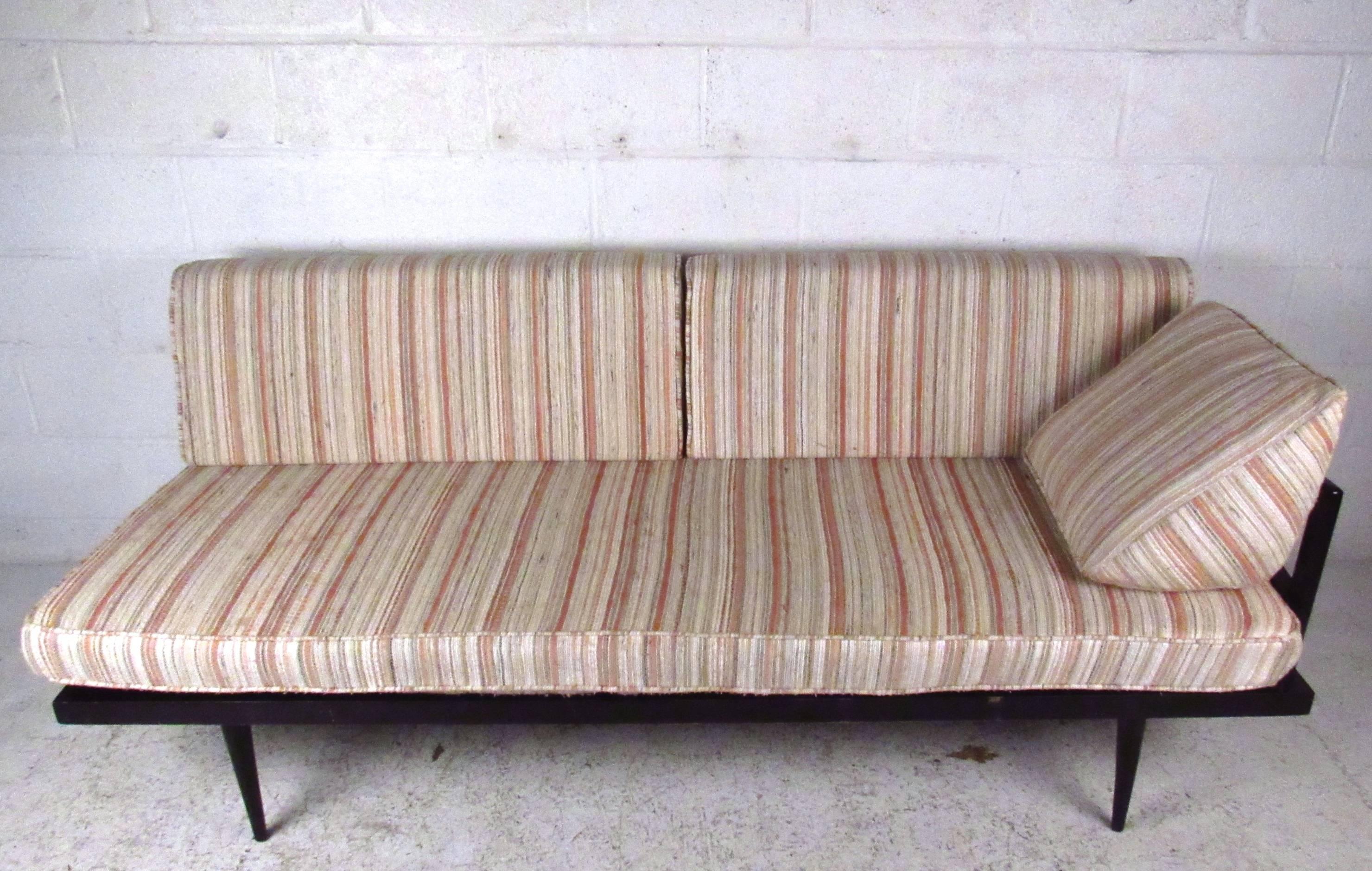 Beautiful vintage daybed features tapered legs, lacquered finish, and sculpted single arm rest. Wedge shaped cushion makes this a comfortable option for laying out or for casual seating. Please confirm item location (NY or NJ). 