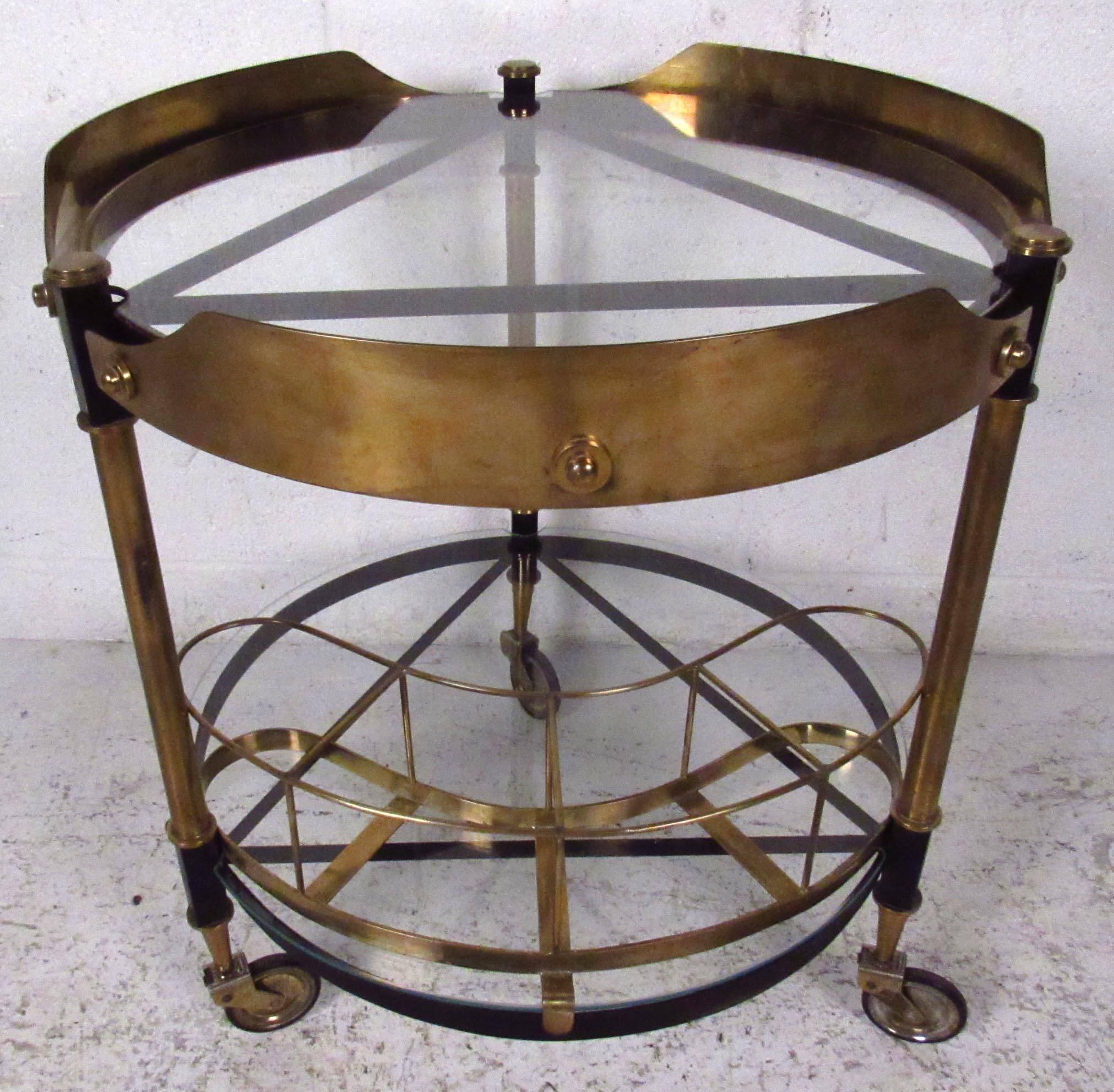 Vintage-modern serving cart featuring sculpted bronze and iron body with glass inserts. The stylish geometric approach to this midcentury Italian bar cart makes a striking and versatile addition to home or business. 

Please confirm item location