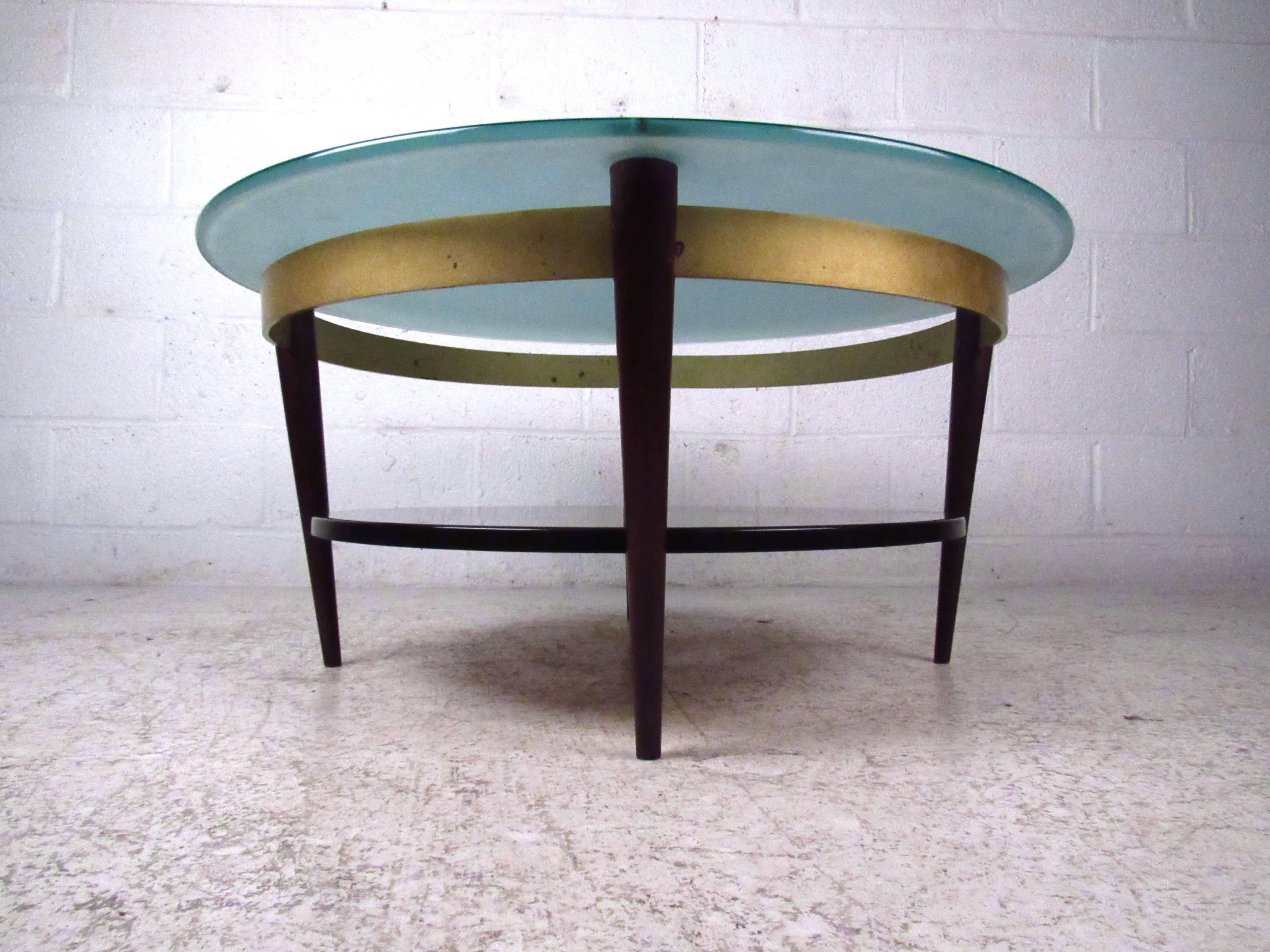This unique frosted glass top coffee table features two tier design with vintage brass trim. Sturdy construction with wonderful mid-century design make this a unique table for any setting. Please confirm item location (NY or NJ). 