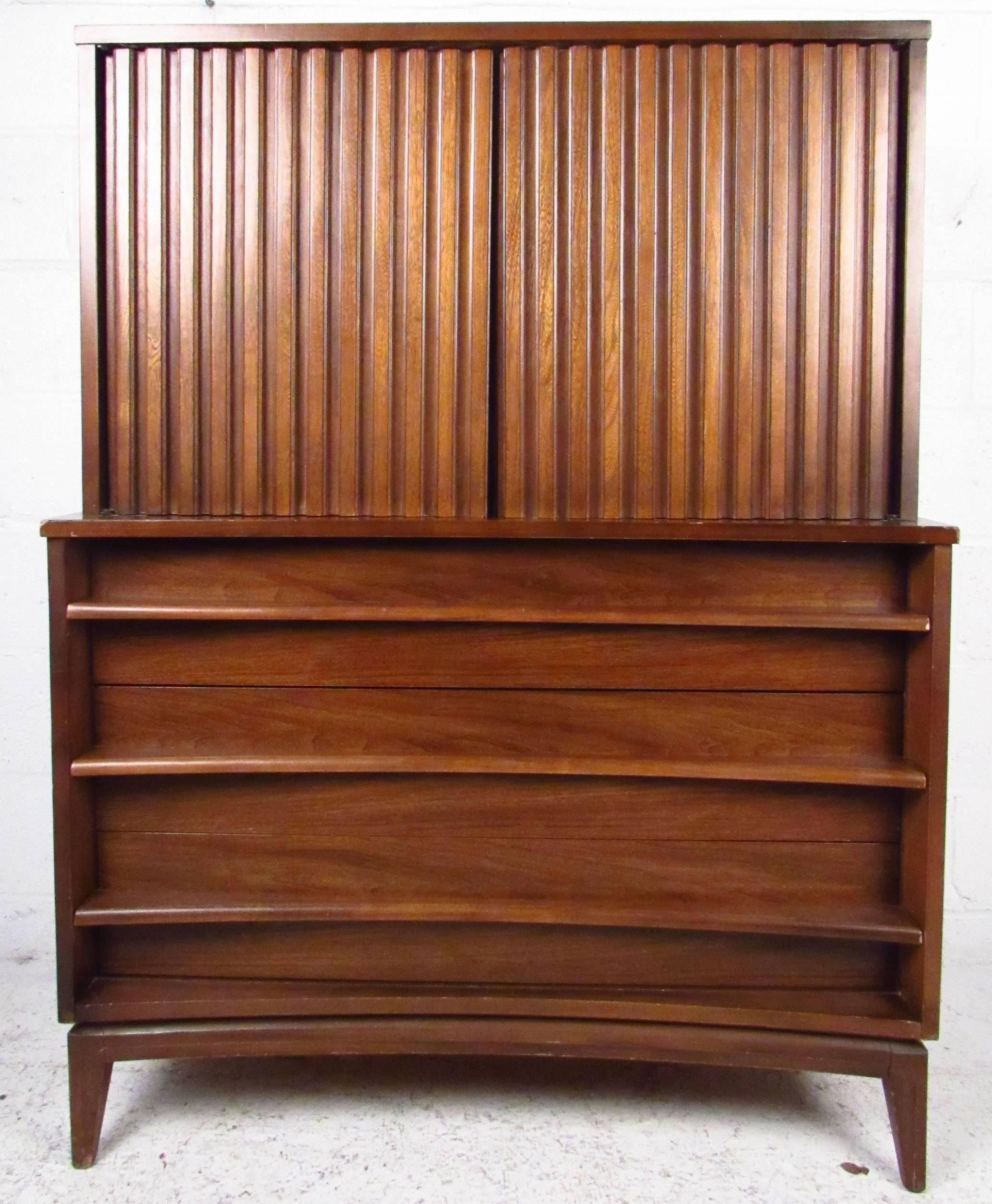 Vintage-modern highboy dresser featuring three bottom drawers with sculpted pulls and one cabinet revealing two inner drawers.

Please confirm item location NY or NJ with dealer.