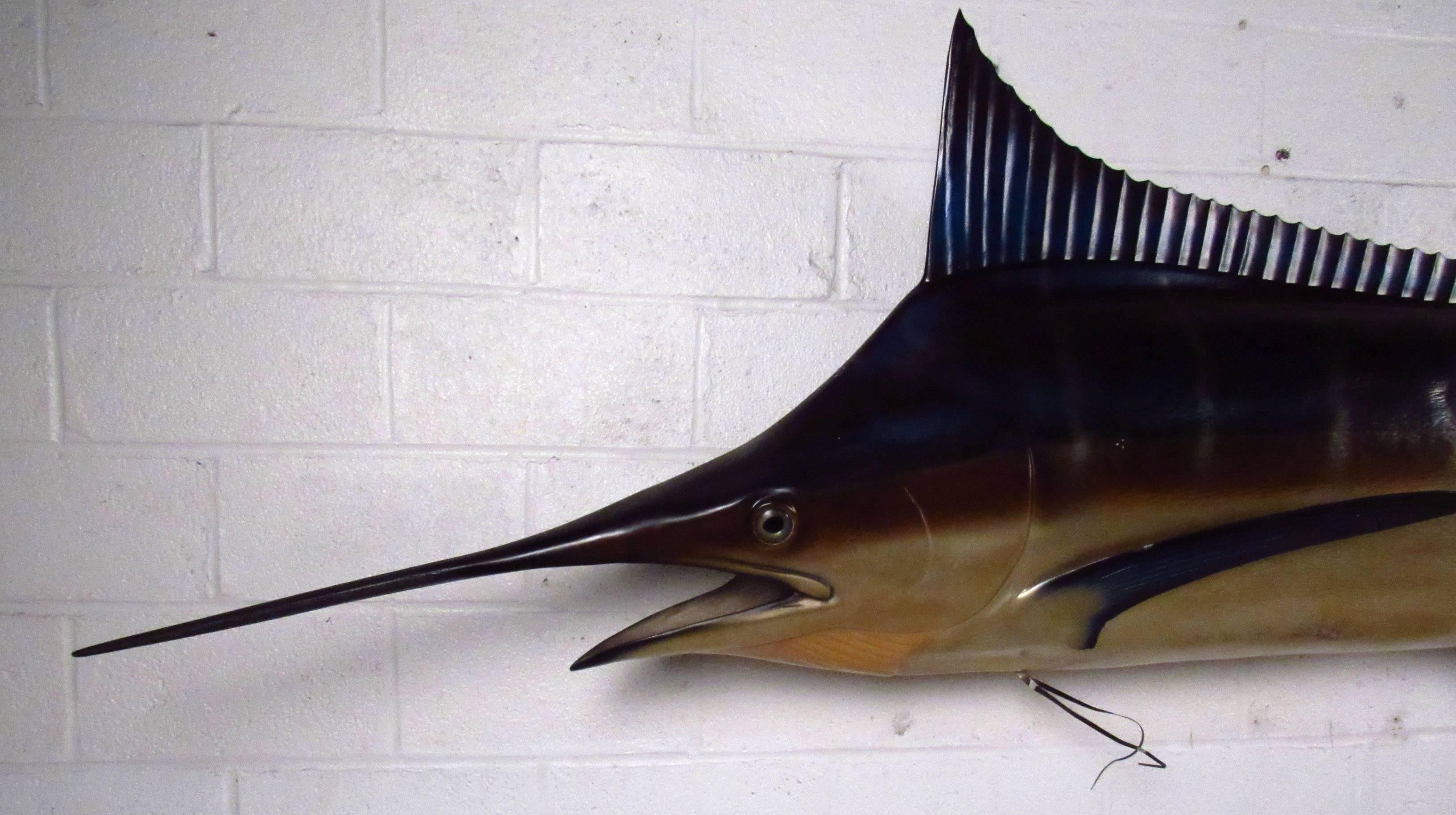 Large wall-mounted swordfish, solid fiberglass construction. Very impressive scale, sure to make a statement in any restaurant setting or beach house. Please confirm item location NY or NJ with dealer.