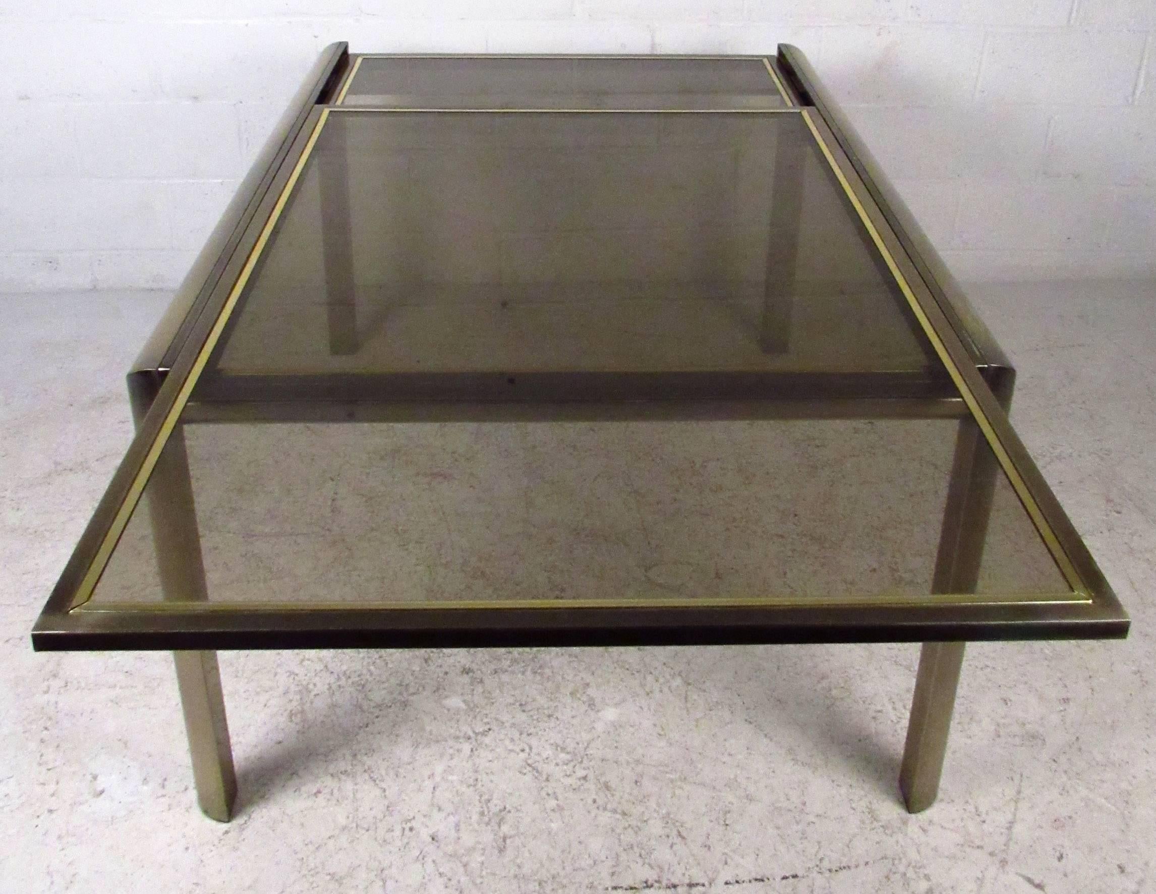 Vintage-modern dining table featuring a sleek bronze finished metal frame and tinted glass top, manufactured by Mastercraft.

Closed dimension: 53W

Please confirm item location NY or NJ with dealer.