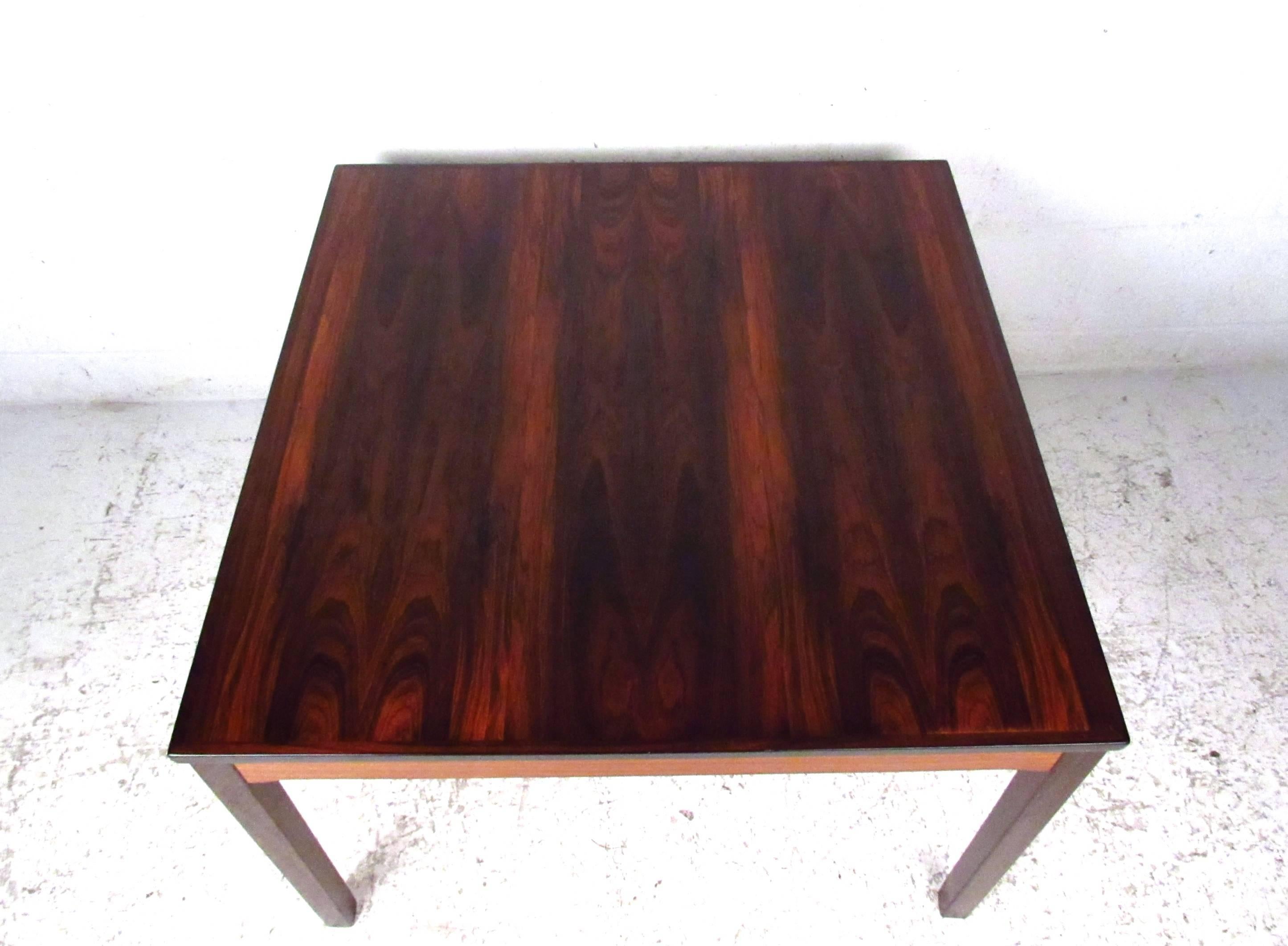 This Norwegian rosewood coffee table by Bruksbo offers a rich natural rosewood finish, with wonderfully banded lightened side supports. Quality midcentury construction makes this vintage table a unique addition to any interior. Please confirm item