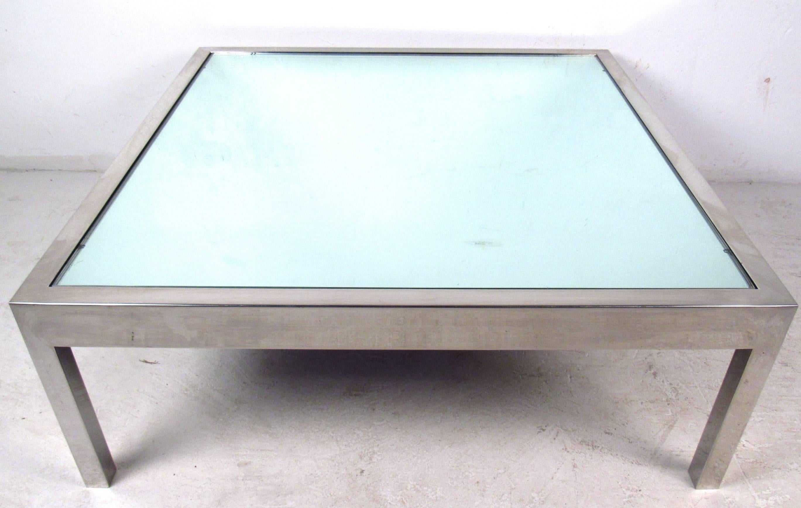 This stylish midcentury chrome cocktail table features a sturdy table base completed with vintage mirrored glass insert. This substantial coffee table makes a wonderful addition to any setting. Please confirm item location (NY or NJ).