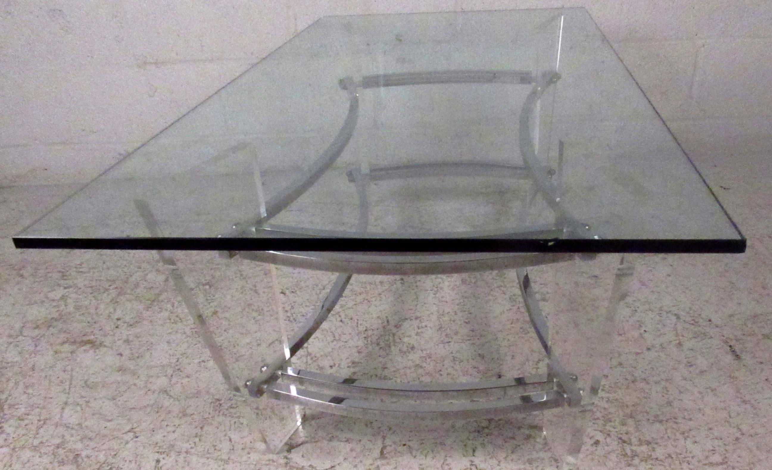 Vintage-modern cocktail table featuring beautifully designed Lucite and chrome base and glass top, designed after Charles Hollis Jones. Stunning mid-century lucite coffee table for home or business seating arrangement.

Please confirm item location