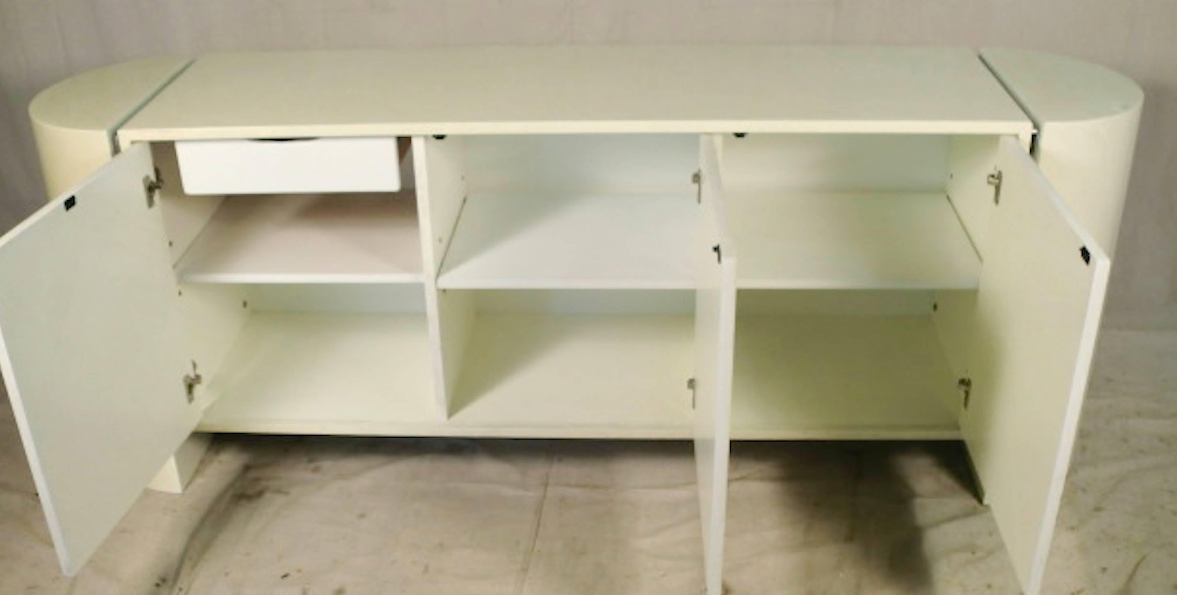 Off white cabinet with hidden storage. In the style of Karl Springer.
(Please confirm item location - NY or NJ - with dealer).
    