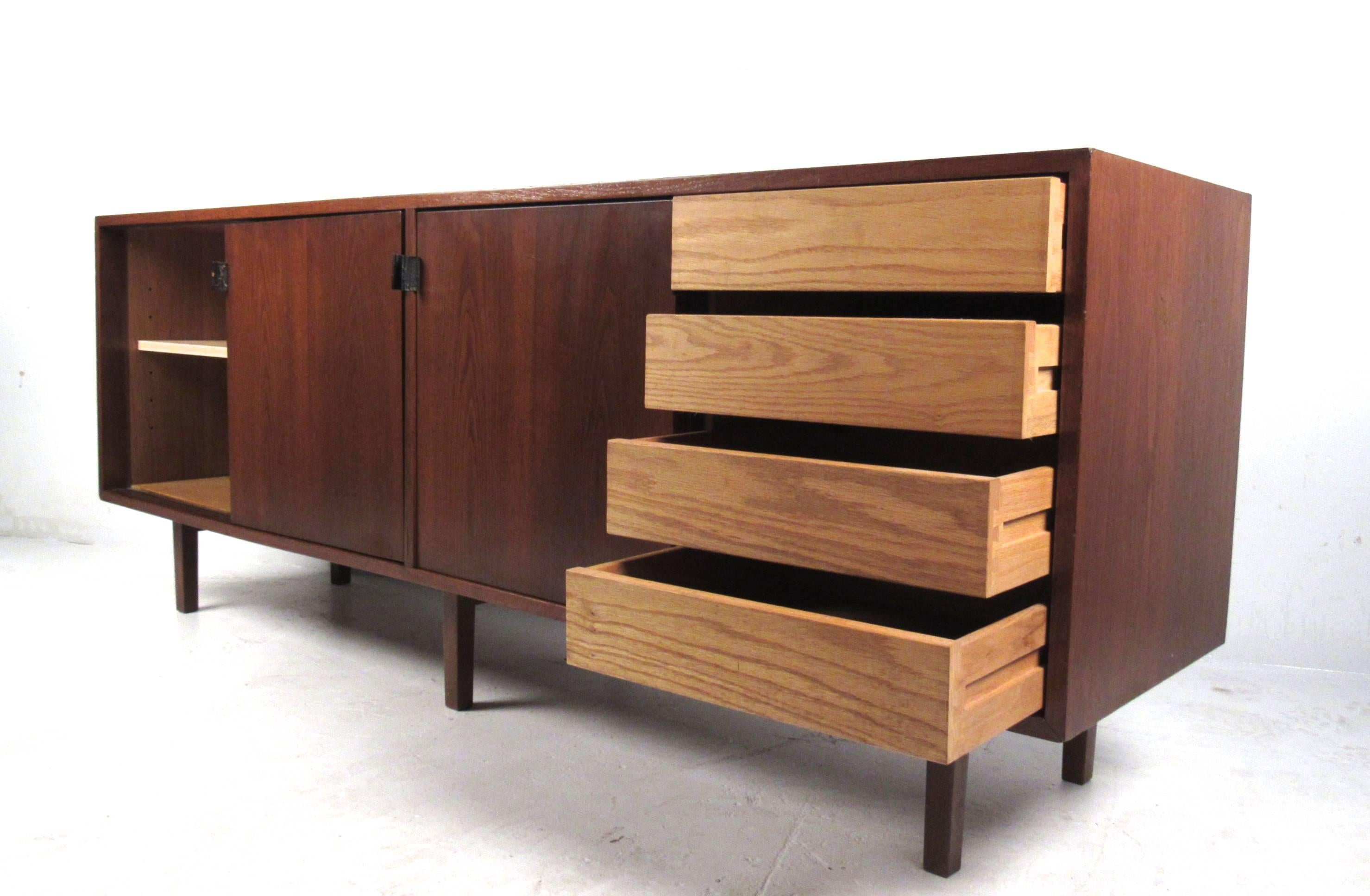 This unique vintage credenza features sliding door cabinets with drawers for added storage. Sturdy six leg construction, leather door pulls and adjustable shelves make this a stylish and versatile piece for any interior. Please confirm item location