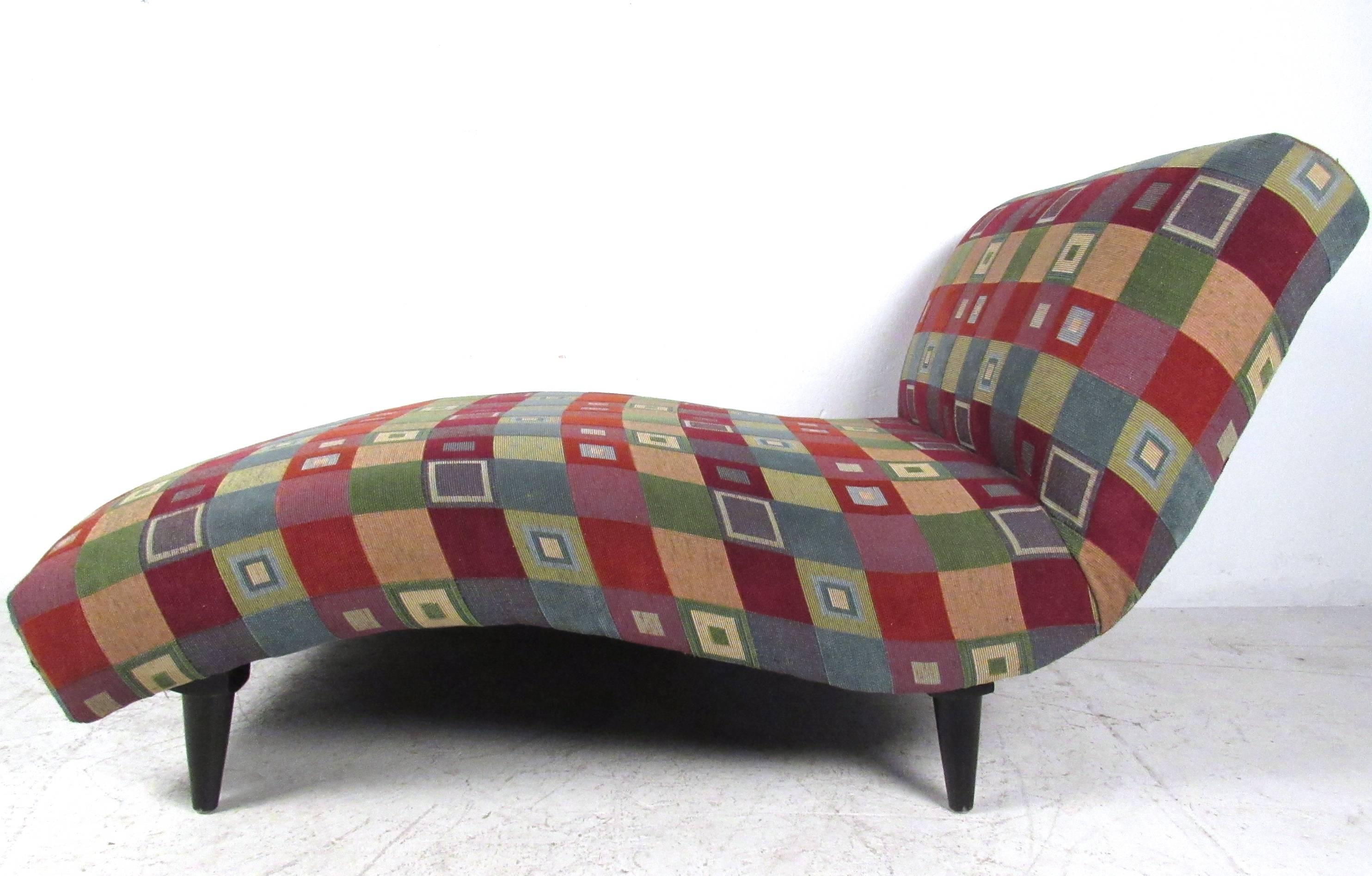 This comfortable and stylish chaise longue makes a wonderful vintage seating addition to any interior. Wide frame, contemporary upholstery, and tapered legs make this a unique reclined seating option for up to two people. Please confirm item