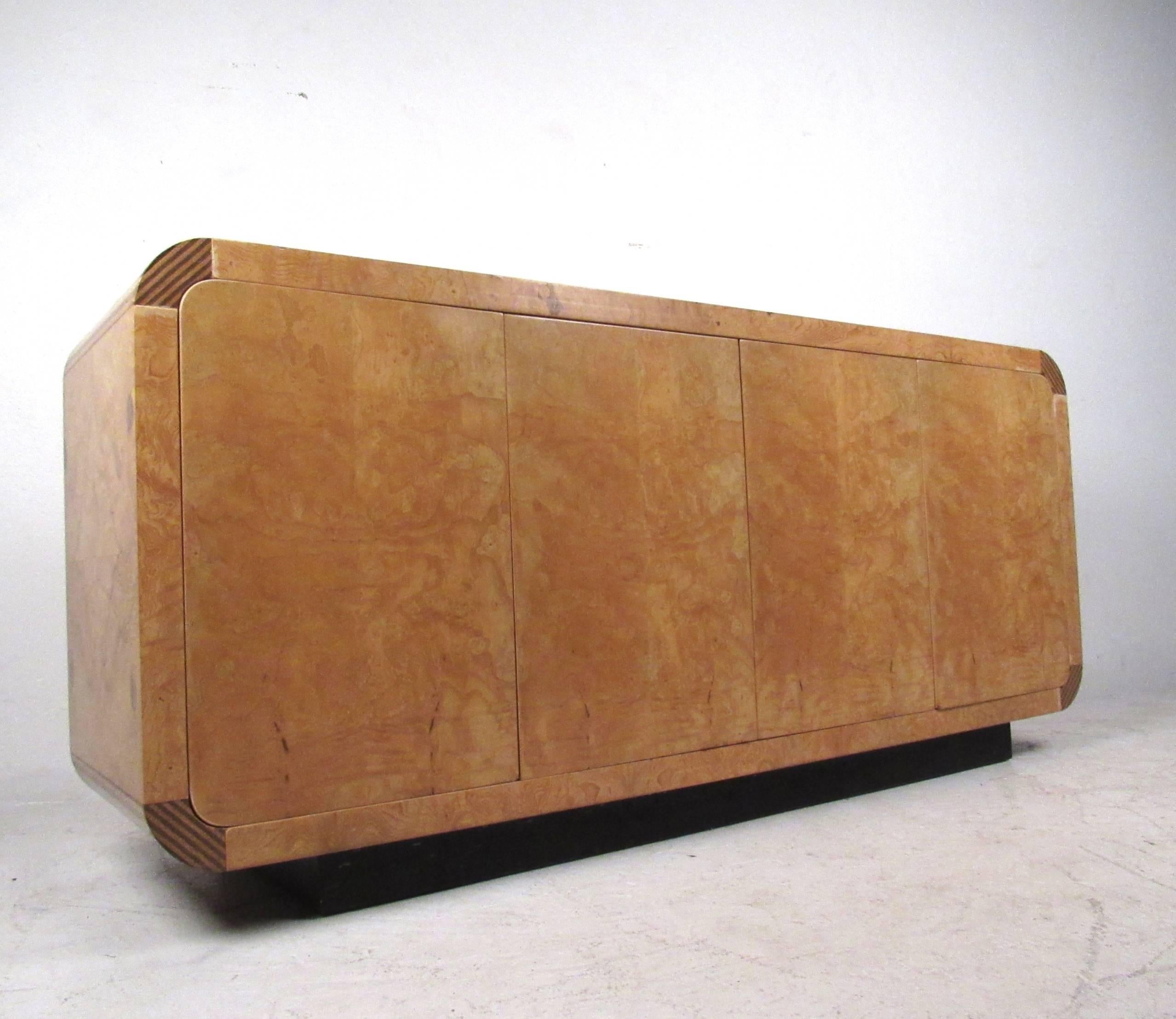 This vintage burl wood credenza by Henredon makes a stylish storage piece for any room. Quality construction, decorative corner inlays, and adjustable shelves round out some of the features of this uniquely sized credenza. Please confirm item