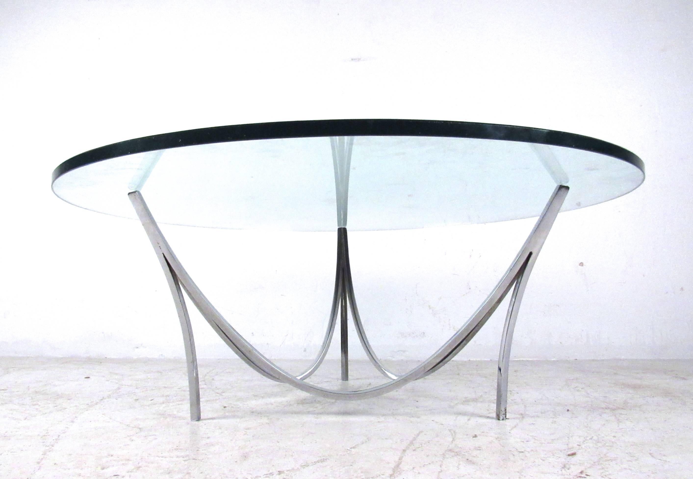This vintage chrome coffee table is beautifully designed, making a stylish midcentury addition to any room. The unique shape of this sturdy metal base is complimented by the circular 1/2 inch glass top. Please confirm item location (NY or NJ).