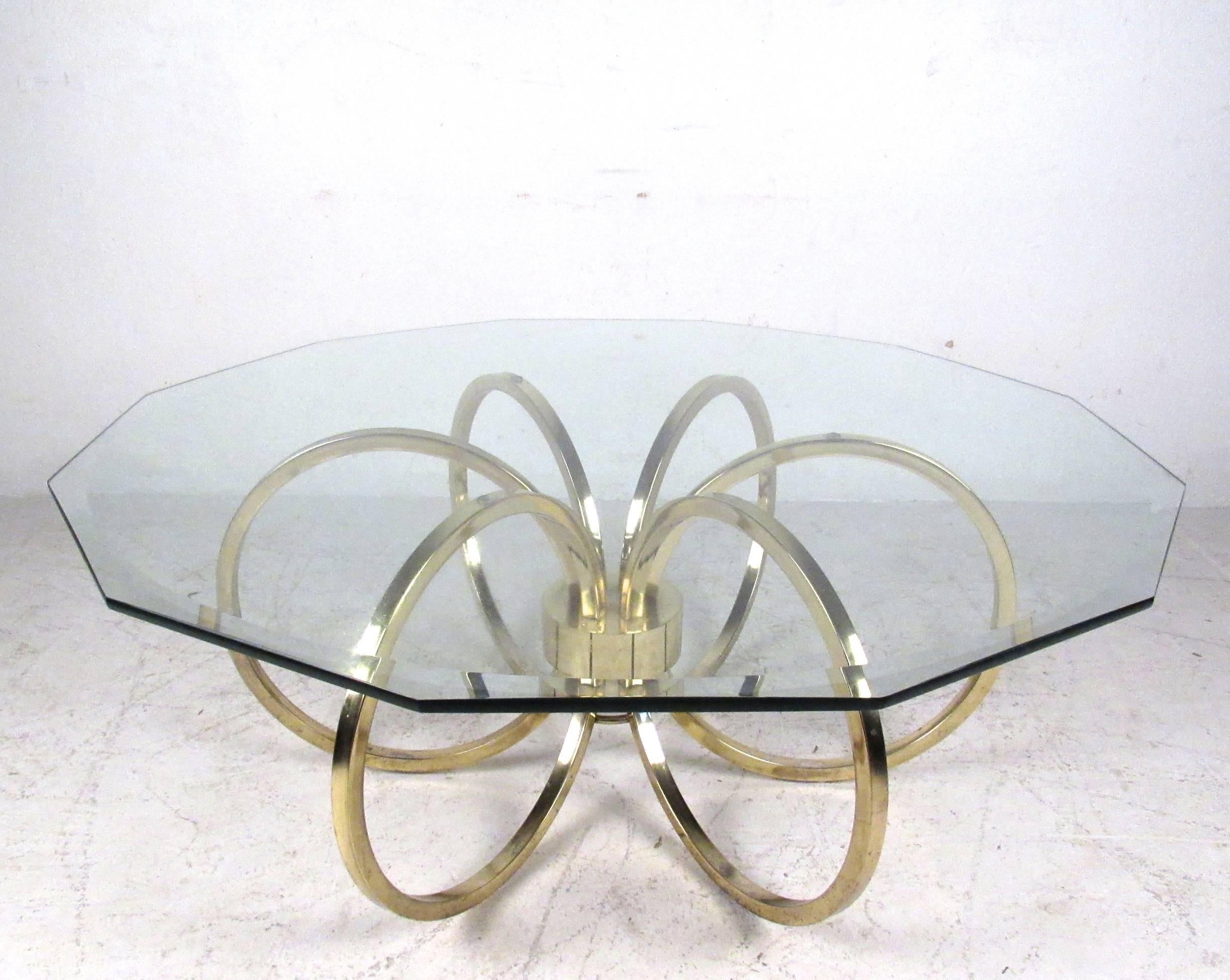 This decorative brass finish coffee table features an octagonal bevelled glass top on sturdy and ornate metal base. Unique style adds elegant vintage flare to any interior. Please confirm item location (NY or NJ).