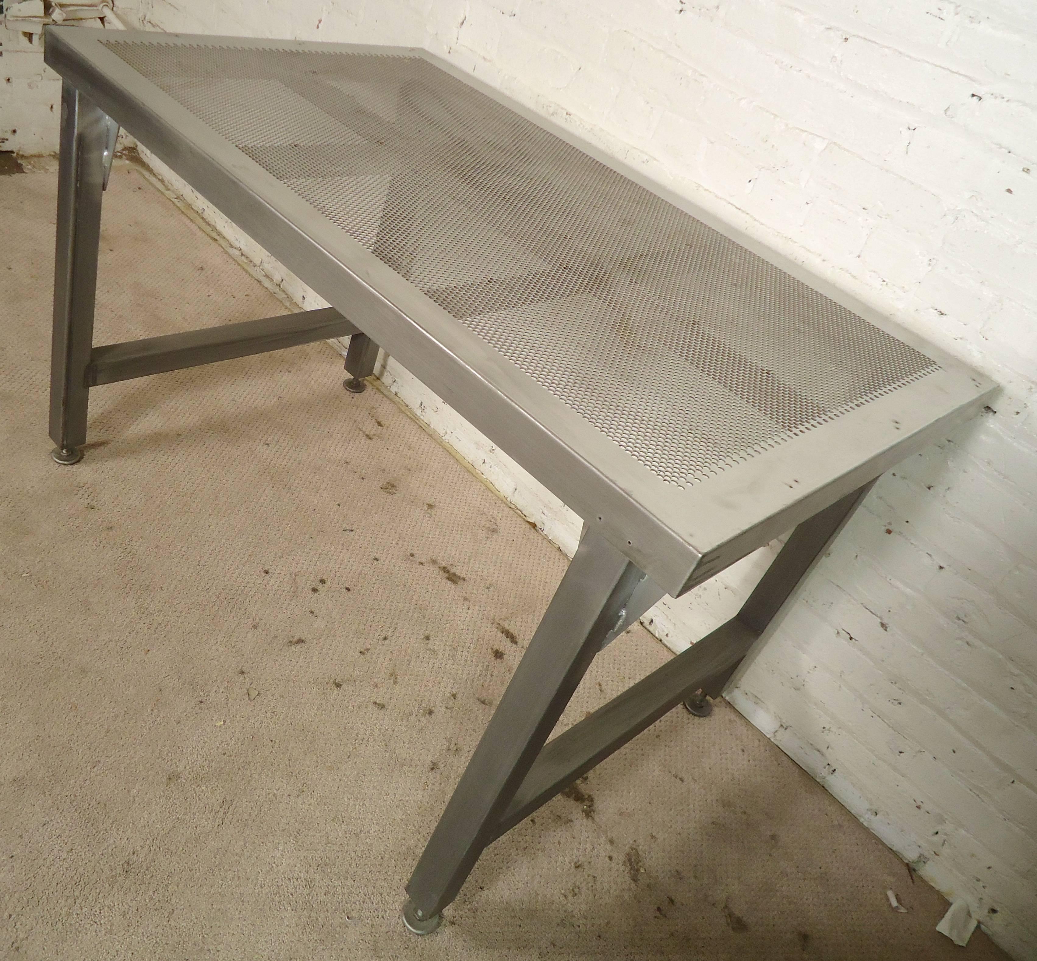 Industrial style table with perforated top and adjustable feet. Gives a strong factory look to your modern home.

(Please confirm item location - NY or NJ - with dealer)
