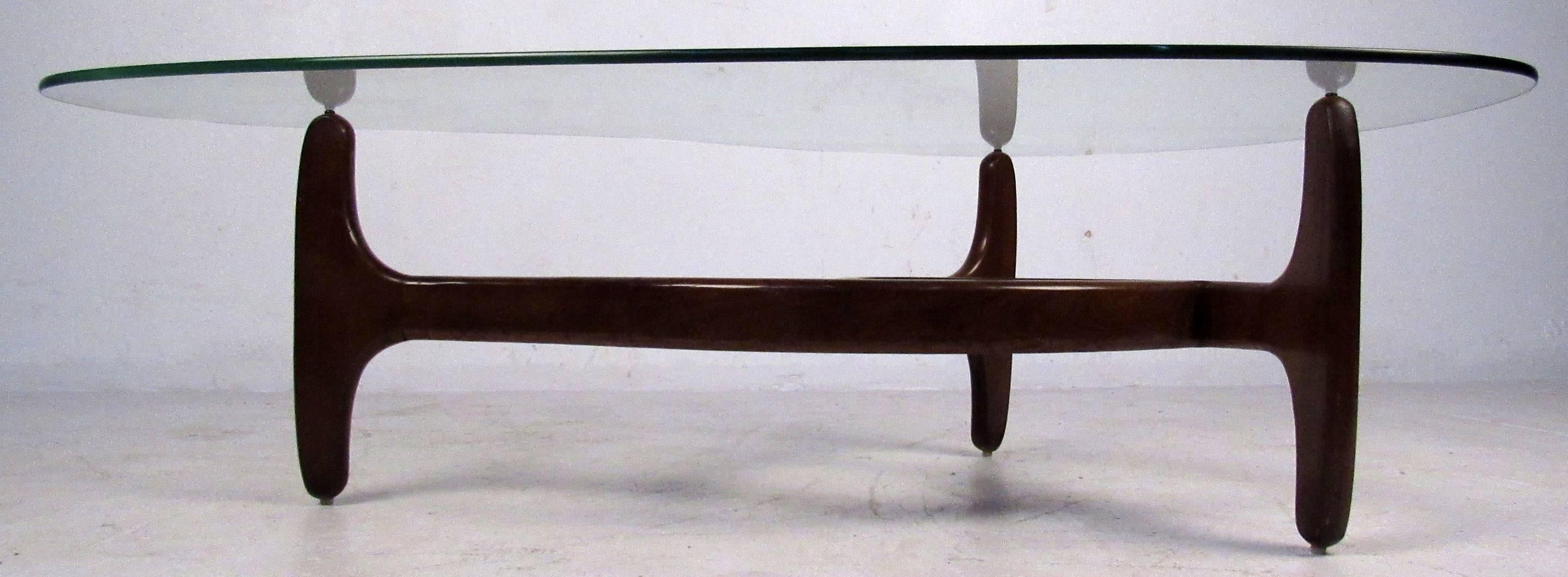 Vintage-modern coffee table featuring kidney shaped glass top and wild sculpted base. Designed in the manner of Adrian Pearsall. 

Please confirm item location NY or NJ with dealer.