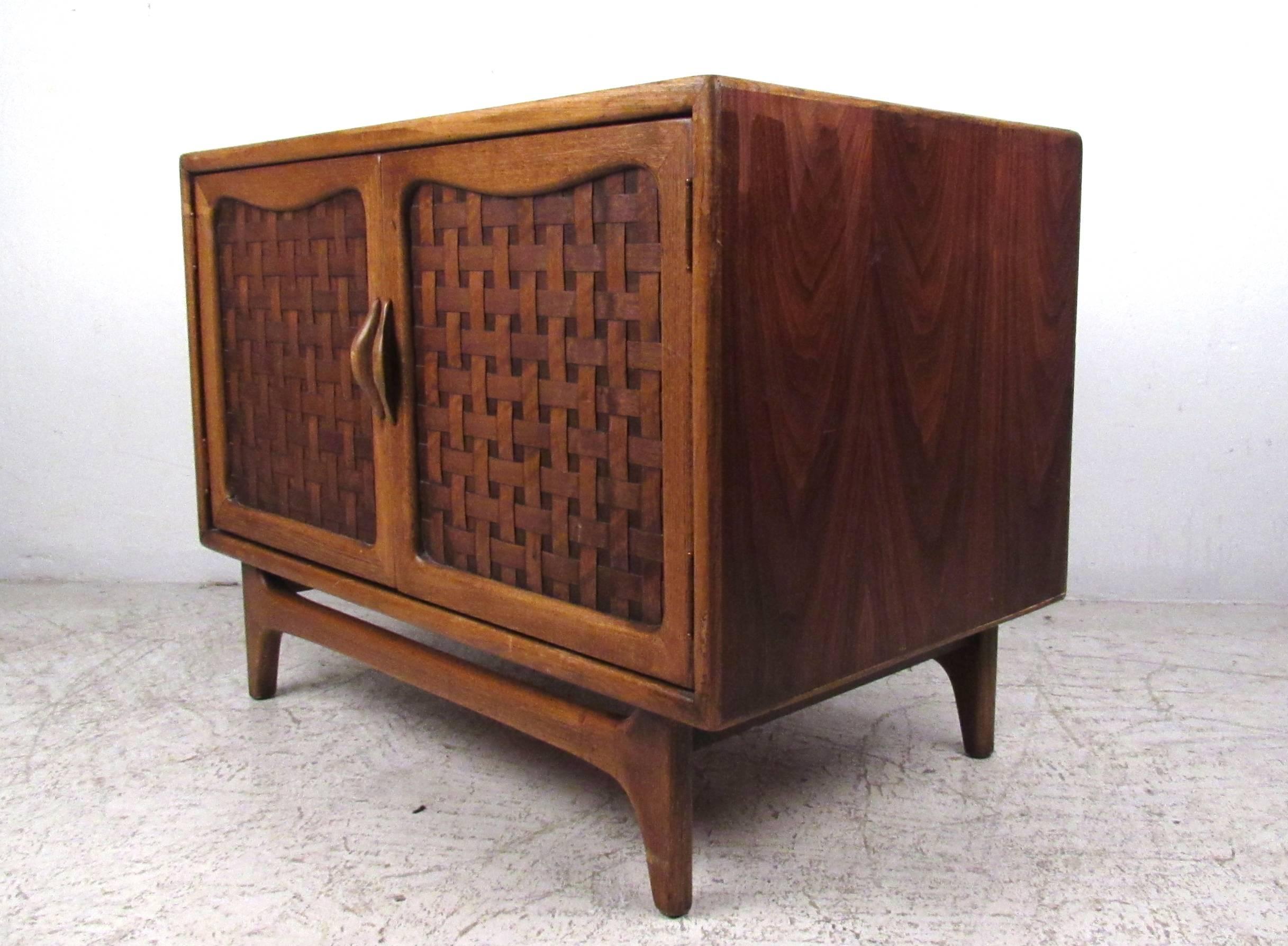 This vintage walnut cabinet by Lane makes a unique storage piece for home office. Ample open storage space, basket weave cabinet doors, and quality vintage Lane Furniture construction make this a wonderful addition to any interior. Please confirm