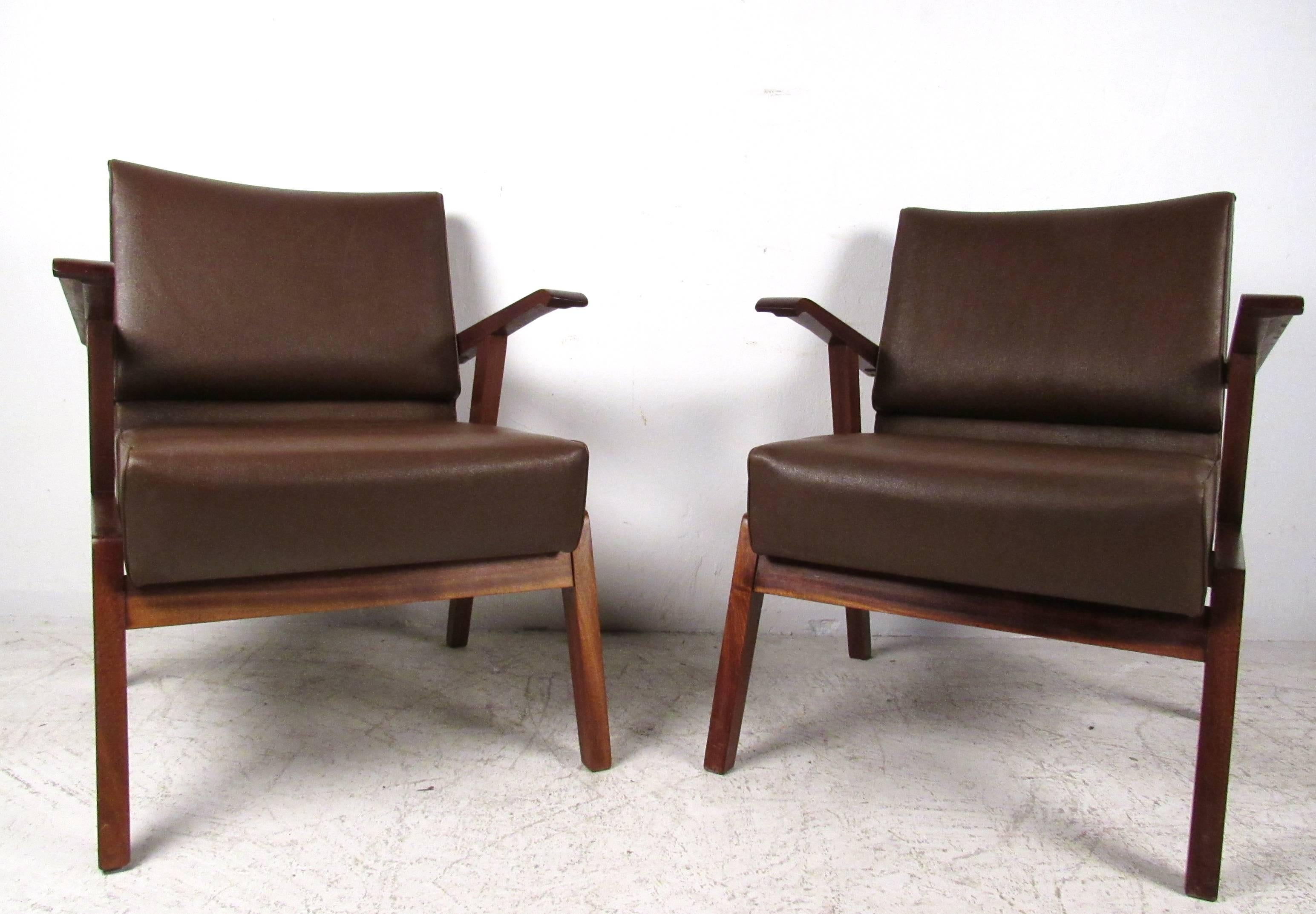 This comfortable pair of vintage Italian hardwood armchairs features a comfortable vinyl upholstered seat and backrest. Studded trim on back of seats, perfect pair for a variety of settings. Second pair available, contact for details. Please confirm