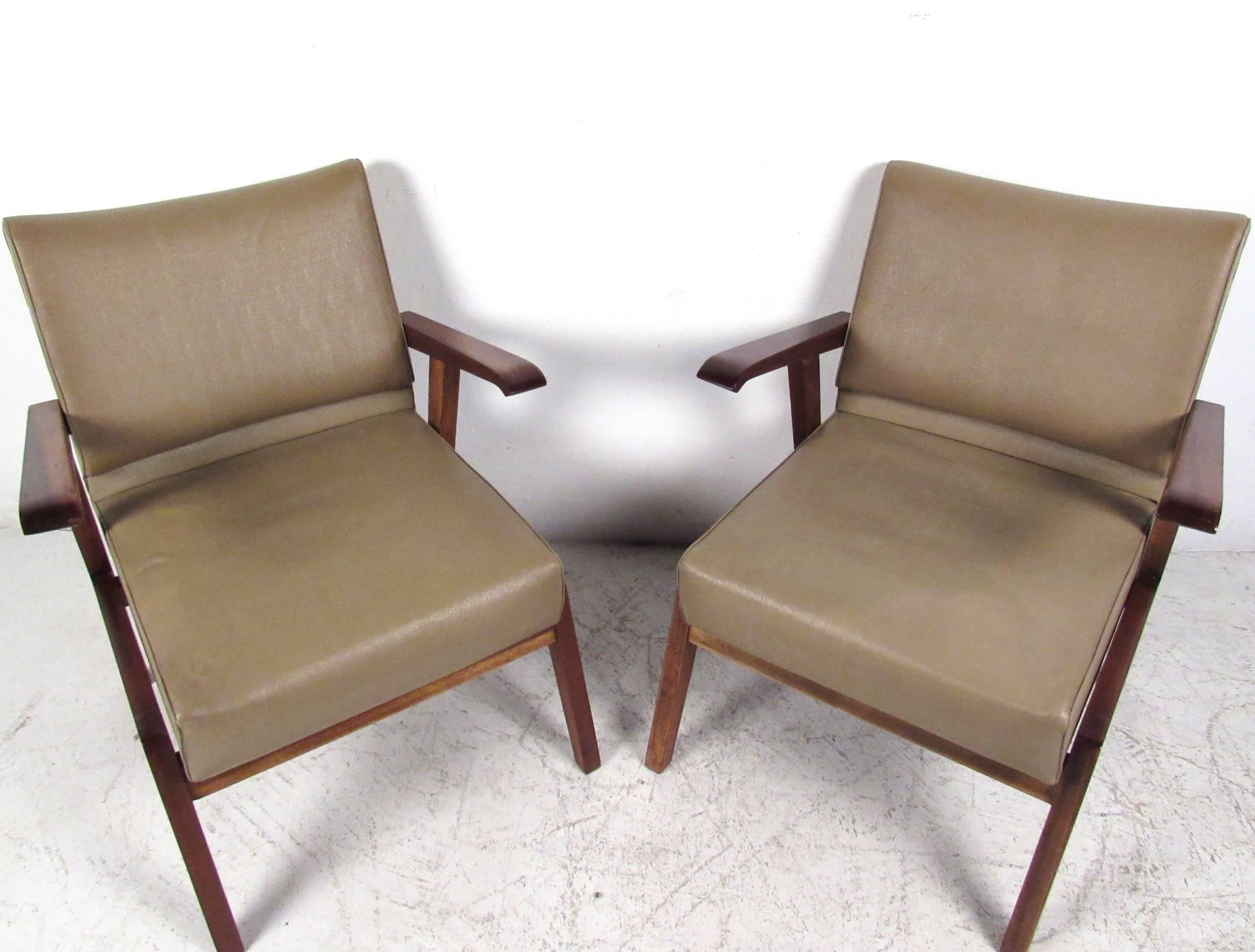 This uniquely styled pair of vintage armchairs make a comfortable and stylish addition to a variety of settings. Ideal for home or office, curved floating hardwood armrests compliment the ergonomic design of the seat back. Magazzini Generali. Please