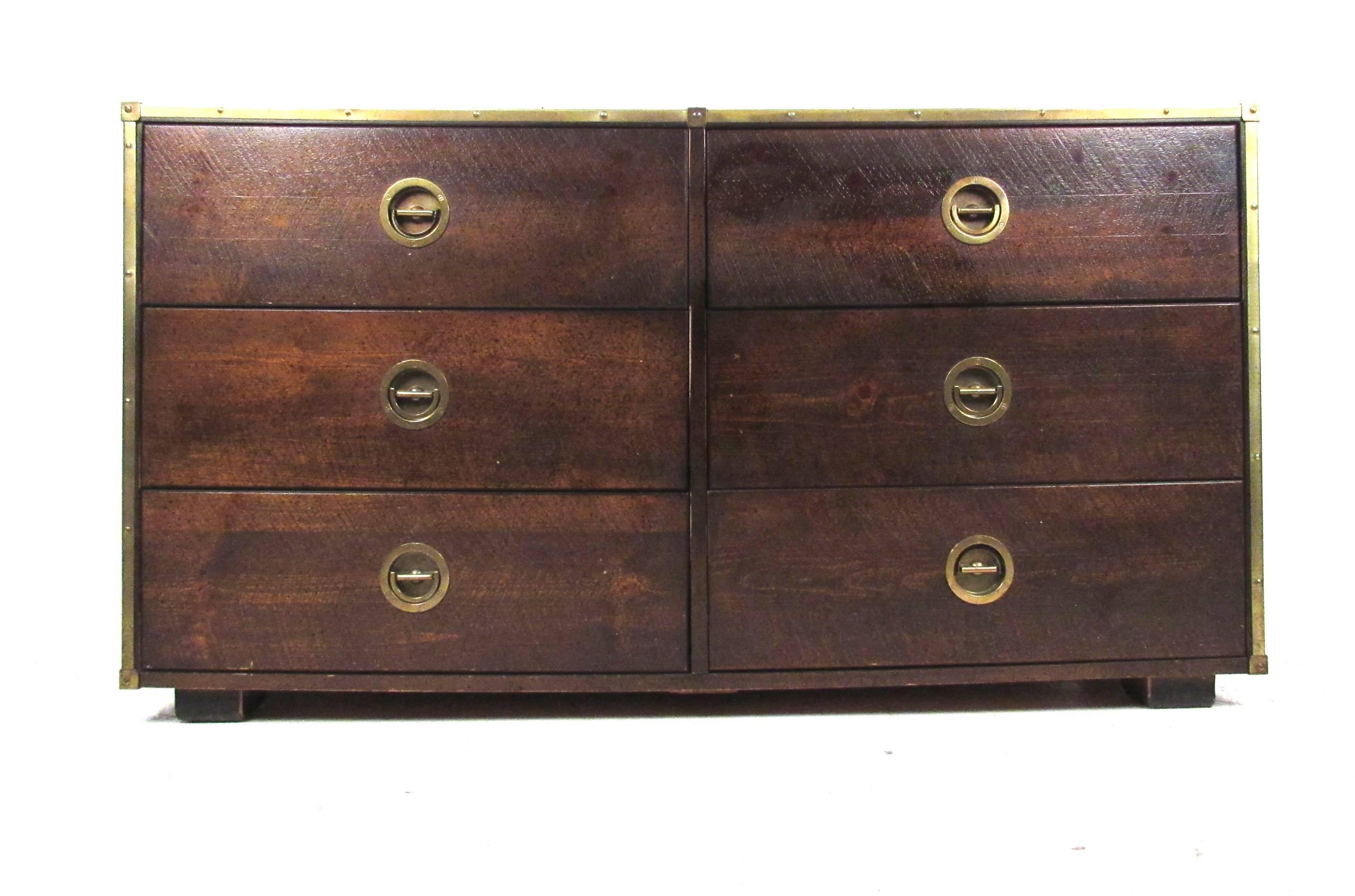 Classic six-drawer textured wood with brass trim Campaign style dresser marked Basset. Please confirm item location (NY or NJ) with dealer.