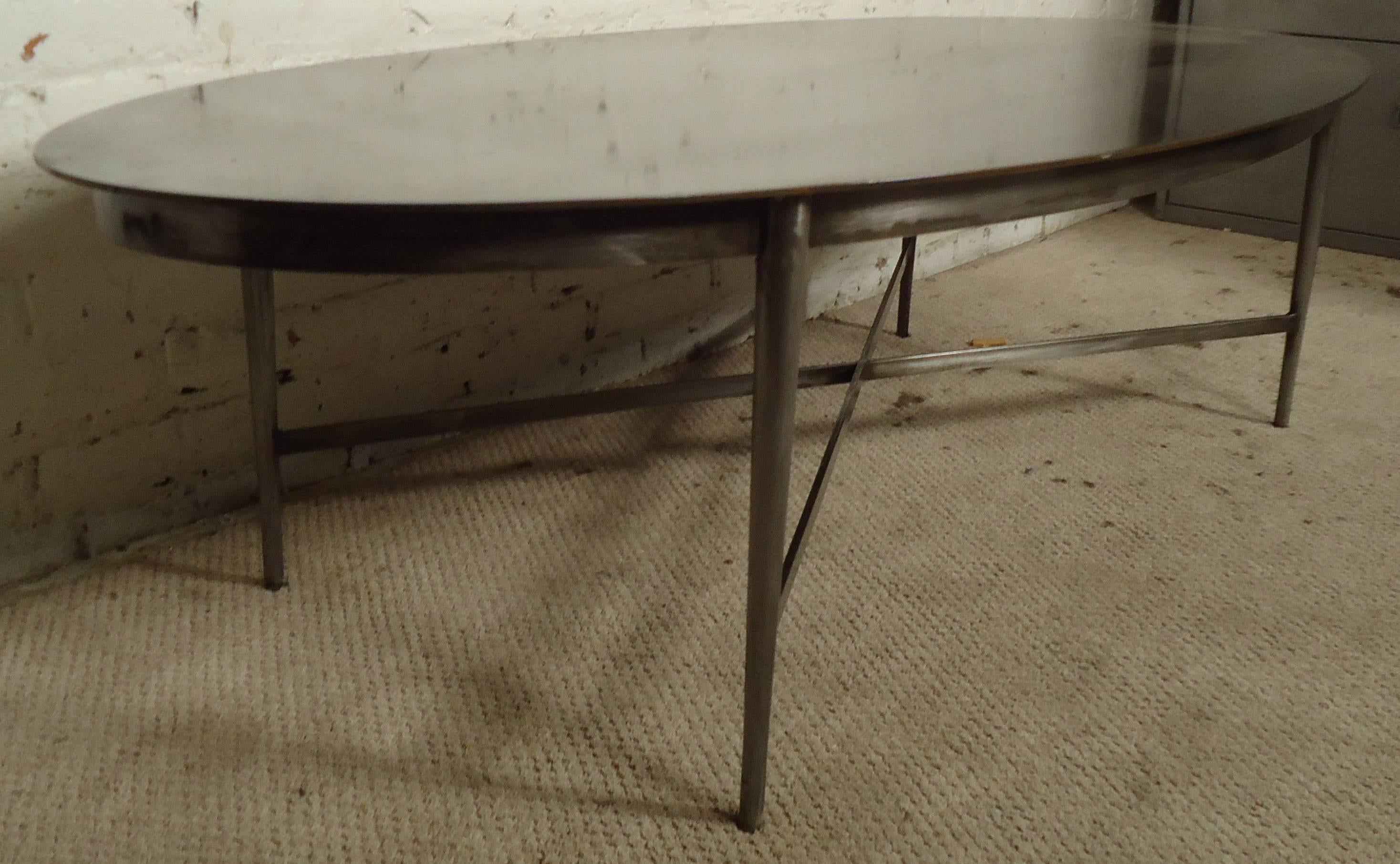 Vintage-modern industrial style coffee table featuring solidly built x-base and oval top. Please confirm item location NY or NJ with dealer.