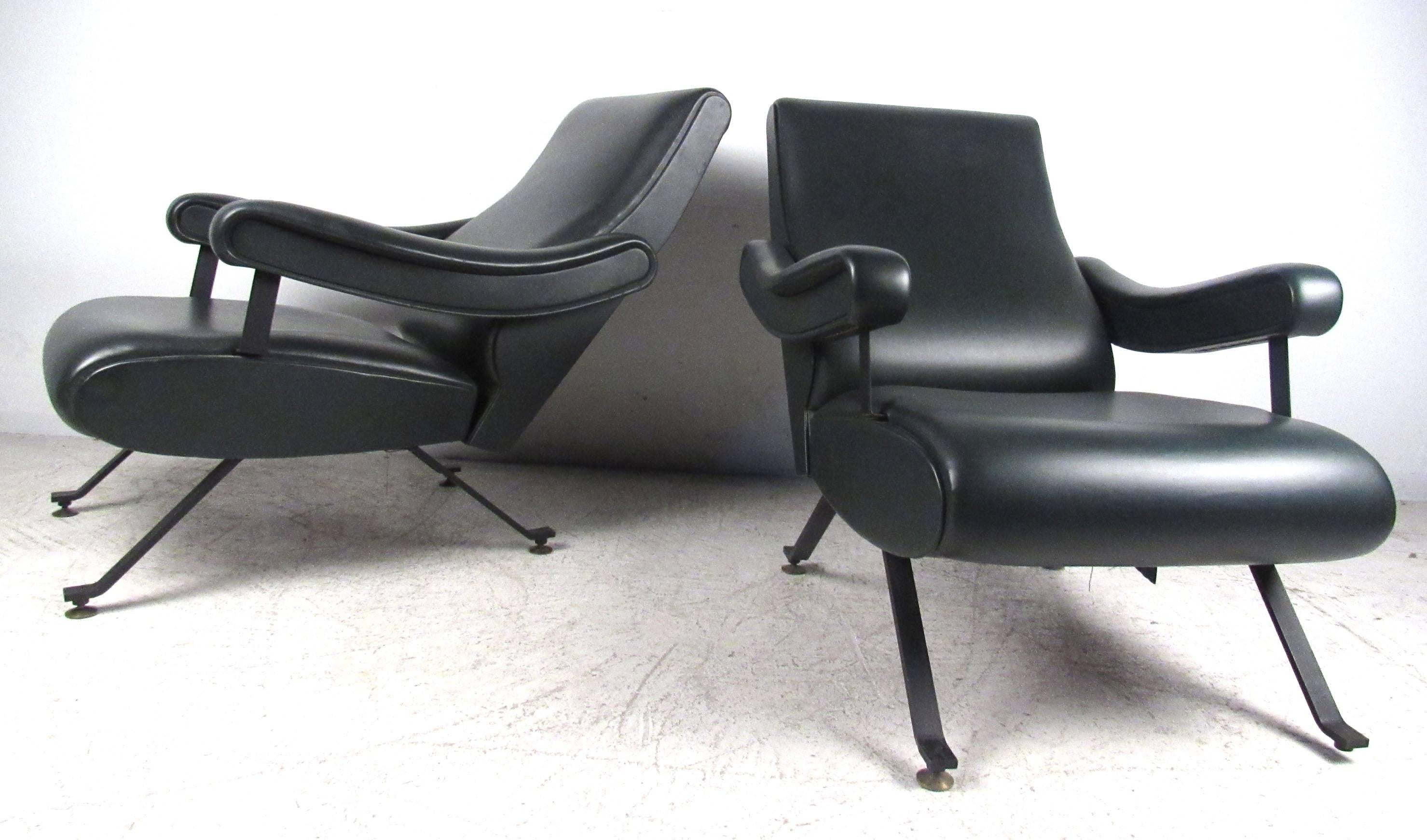 Pair of unique Mid-Century upholstered armchairs with reclining backs in dark green. Please confirm item location (NY or NJ) with dealer.