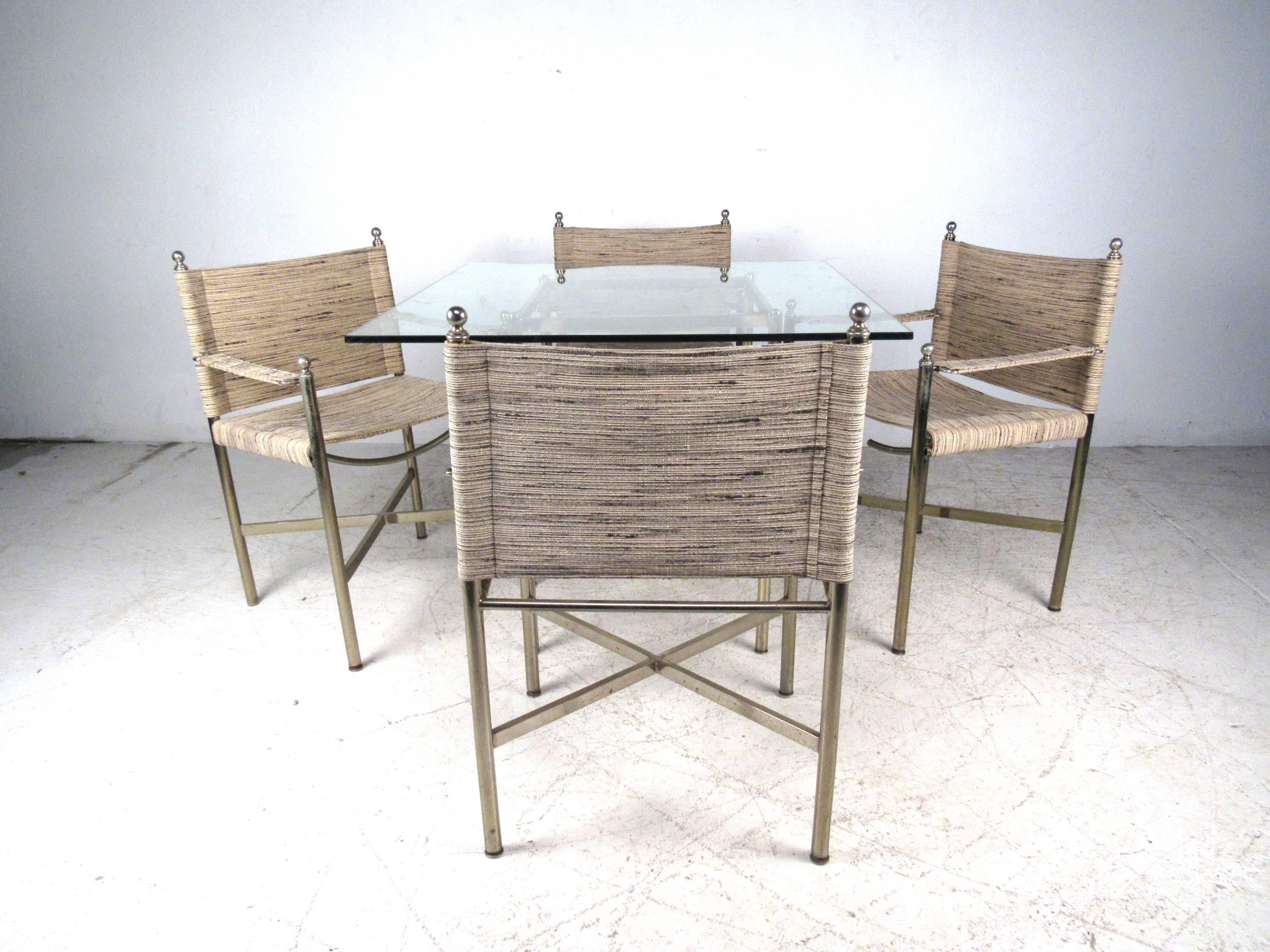 This gorgeous set includes a glass dining table along with four chairs. The stylish brass base and the unique fabric of the chairs make this set a perfect addition to any setting. Table dimensions are 36.25 W, 36.25 D, 28.5 H. 

Please confirm