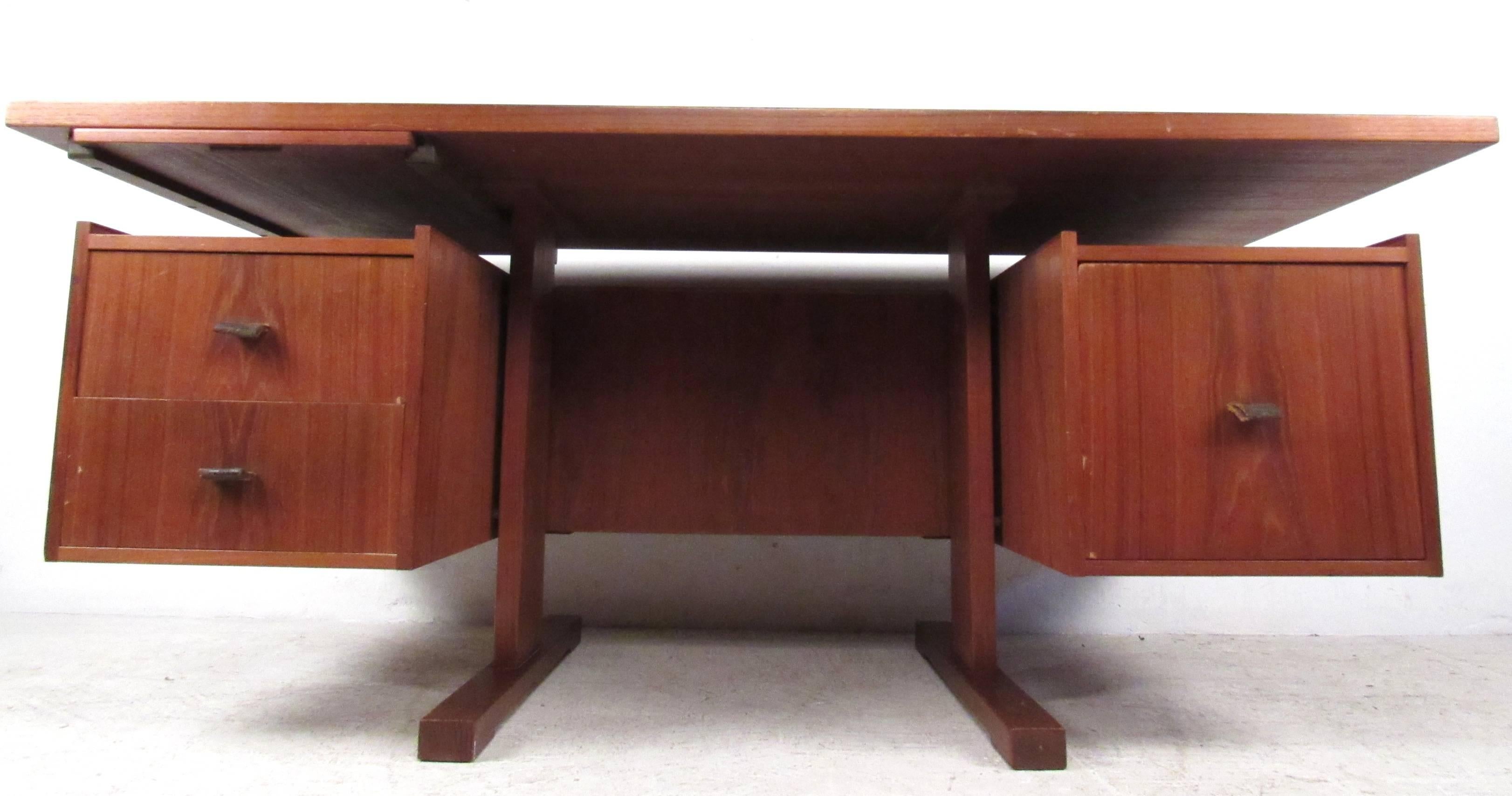 Versatile, double sided Danish modern desk with multiple storage options and retractable work surface. Striking Scandinavian Teak finish and spacious storage makes this the perfect desk for home or office workspace. Please confirm item location (NY