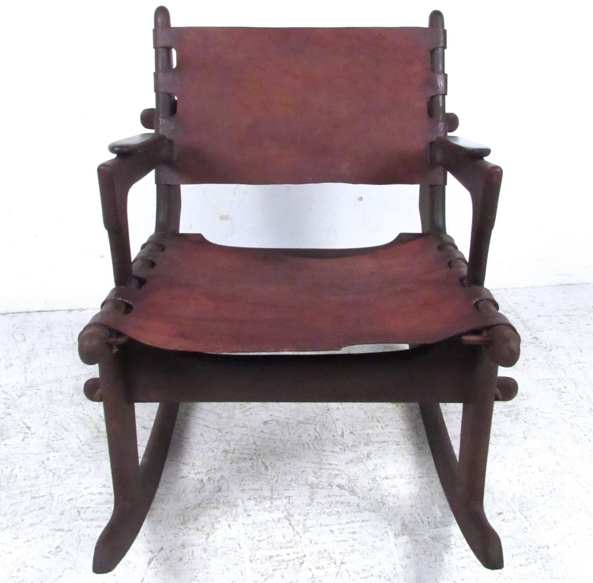 This unique vintage rocking chair by Ecuadorian designer Angel Pazmino features leather seat, and unique dowel construction. A stylish Primitive modern chair in any setting. Please confirm item location (NY or NJ).