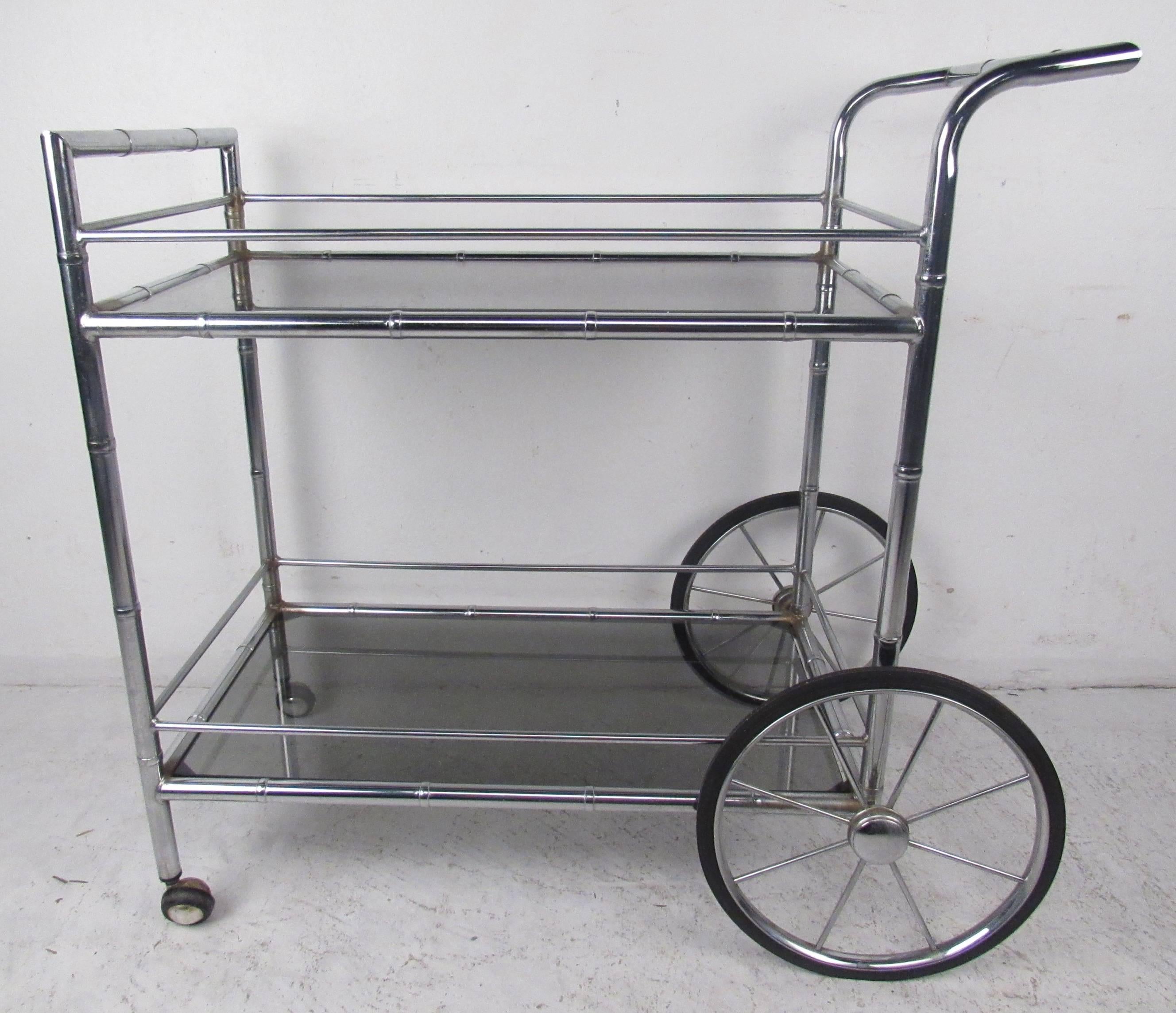 Chrome serving cart with bamboo motif and smoked glass shelves. 
Please confirm item location (NY or NJ) with dealer.